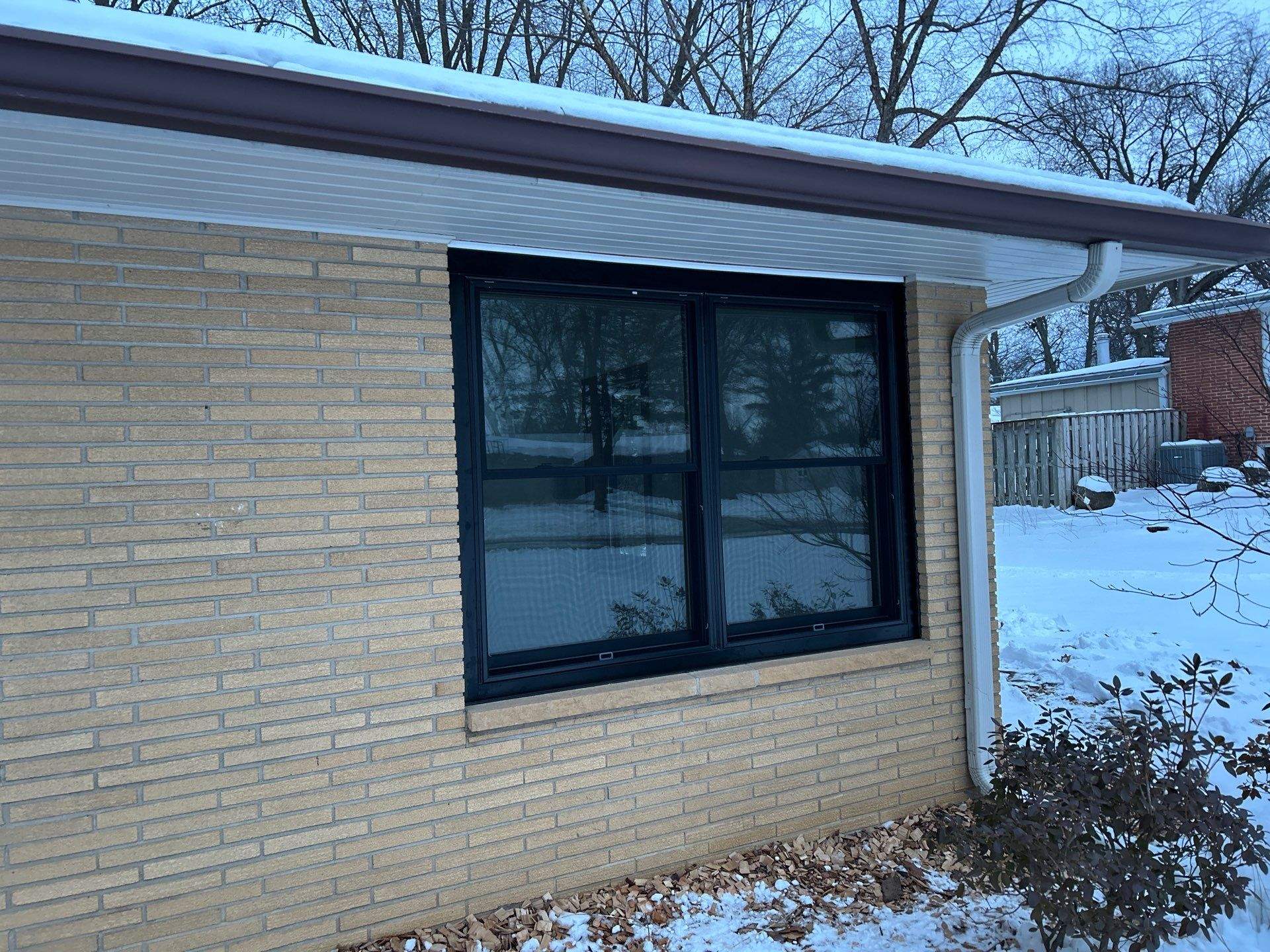 Black-Frame Pella Lifestyle Upgrade on a Partial Brick Home by United Windows and Siding LLC