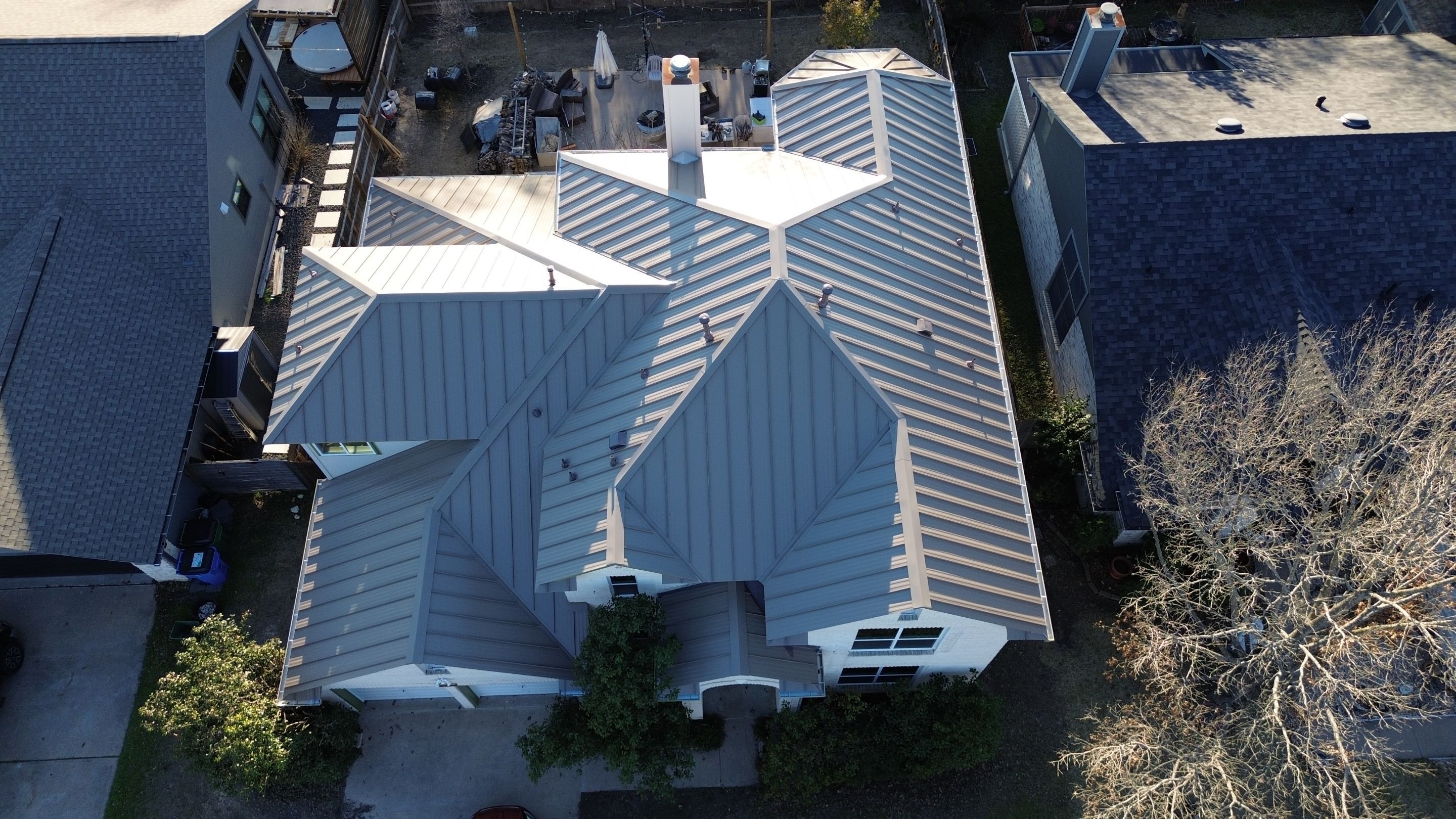 Three Tab Shingles To Metal Standing Seam by DeZign Roofing & Exteriors
