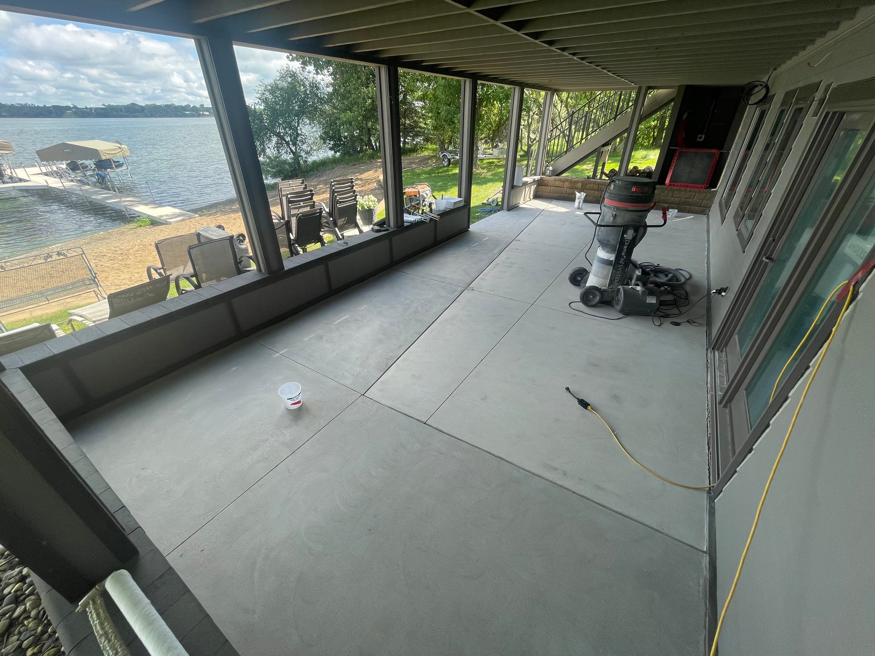 Lakefront Screened Patio Concrete Coating Installation in Wentworth by Select Painting, Coatings & Garage Cabinets