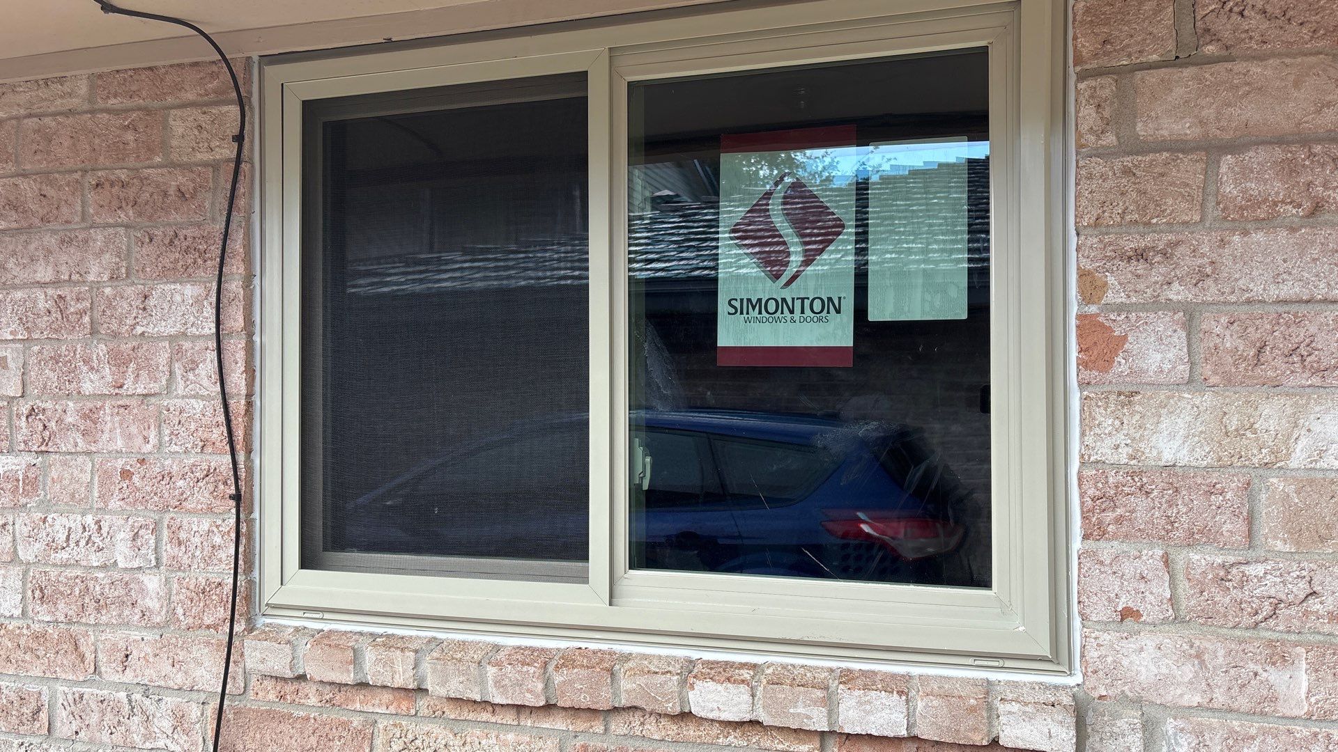 Colored Vinyl Windows to blend into brick by Bayfront Roofing and Construction