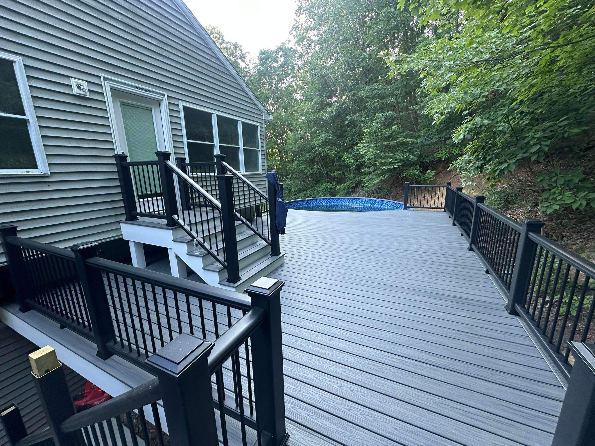 Pool Deck replacement, Trex Tropical Island Mist , Black Transcend railing. by DiGiorgi Roofing and Siding Inc