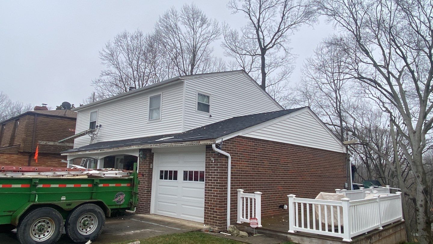 Replace dated vinyl siding with new white exterior Portfolio vinyl siding  by Secure Construction Company Inc