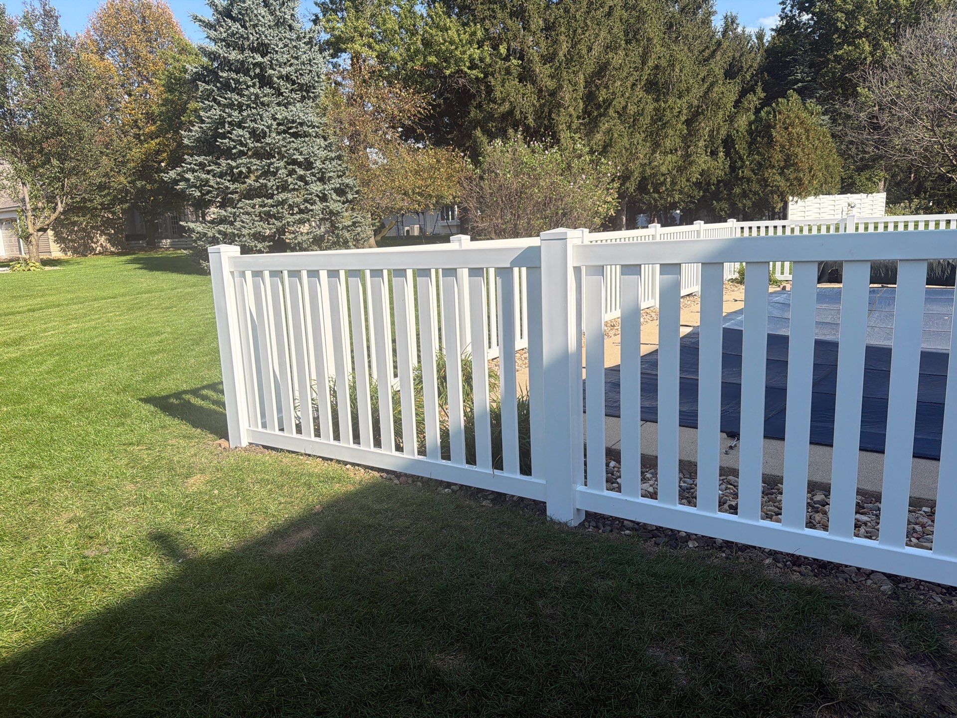 White Vinyl Picket Pool Fence Installation in Waterloo, Iowa by Perfect Picket Fence and Stain