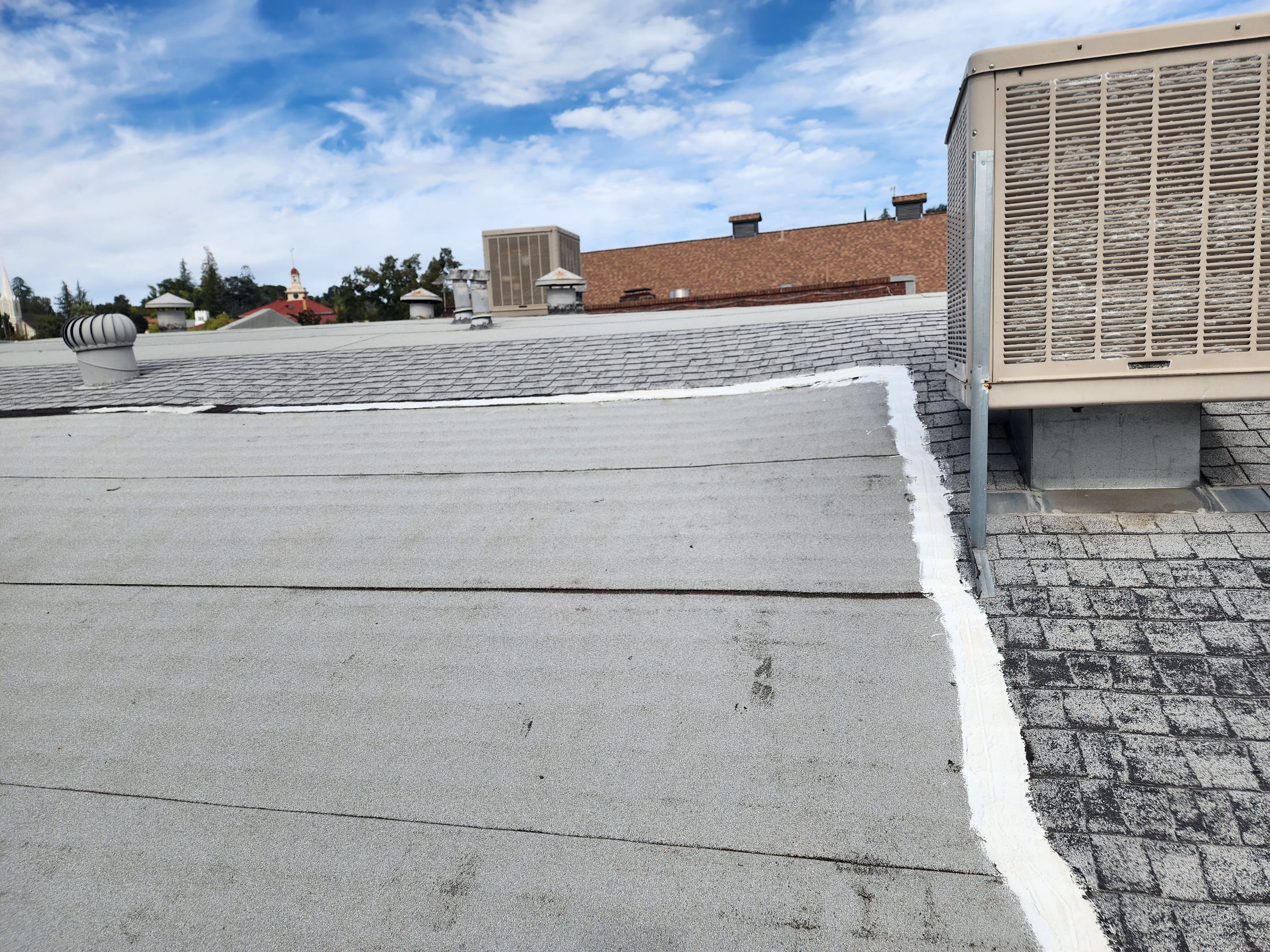 Foam and coatings on commercial roof by Straight Edge Roofing Inc