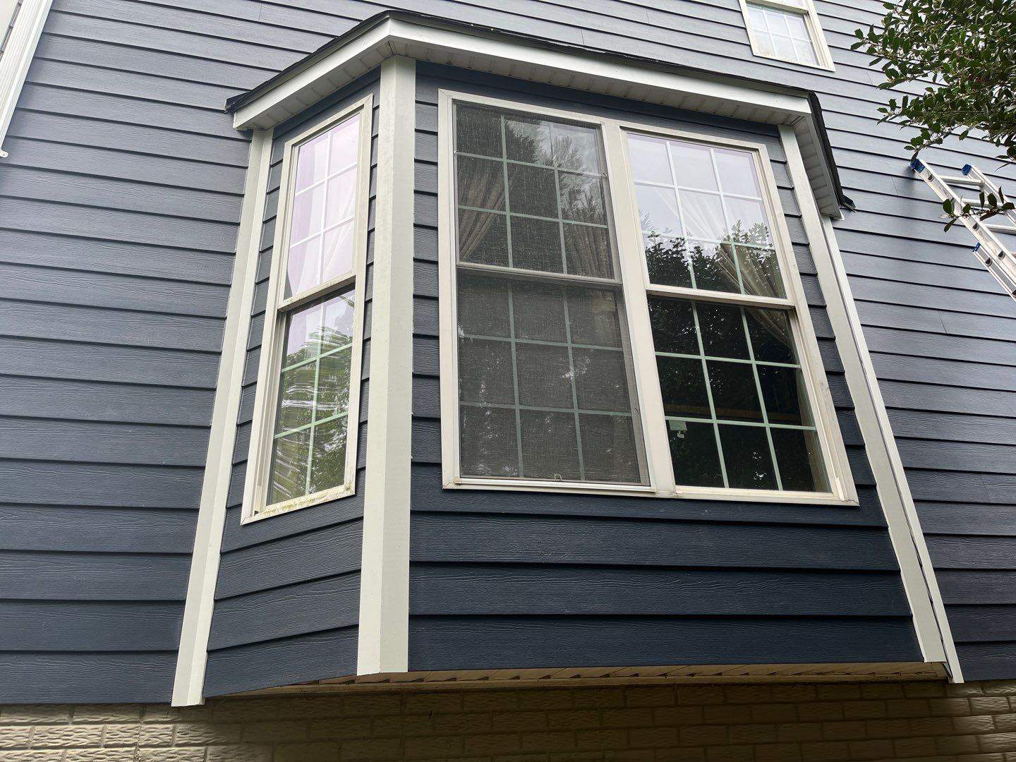 James Hardie Plank Siding + Seamless Gutters by American Home Contractors