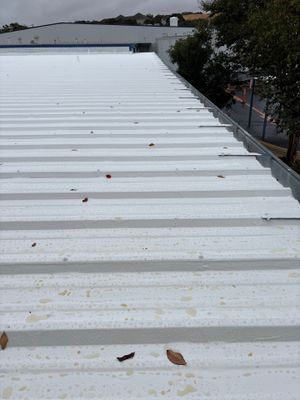 Wide angle view of completed white metal roof