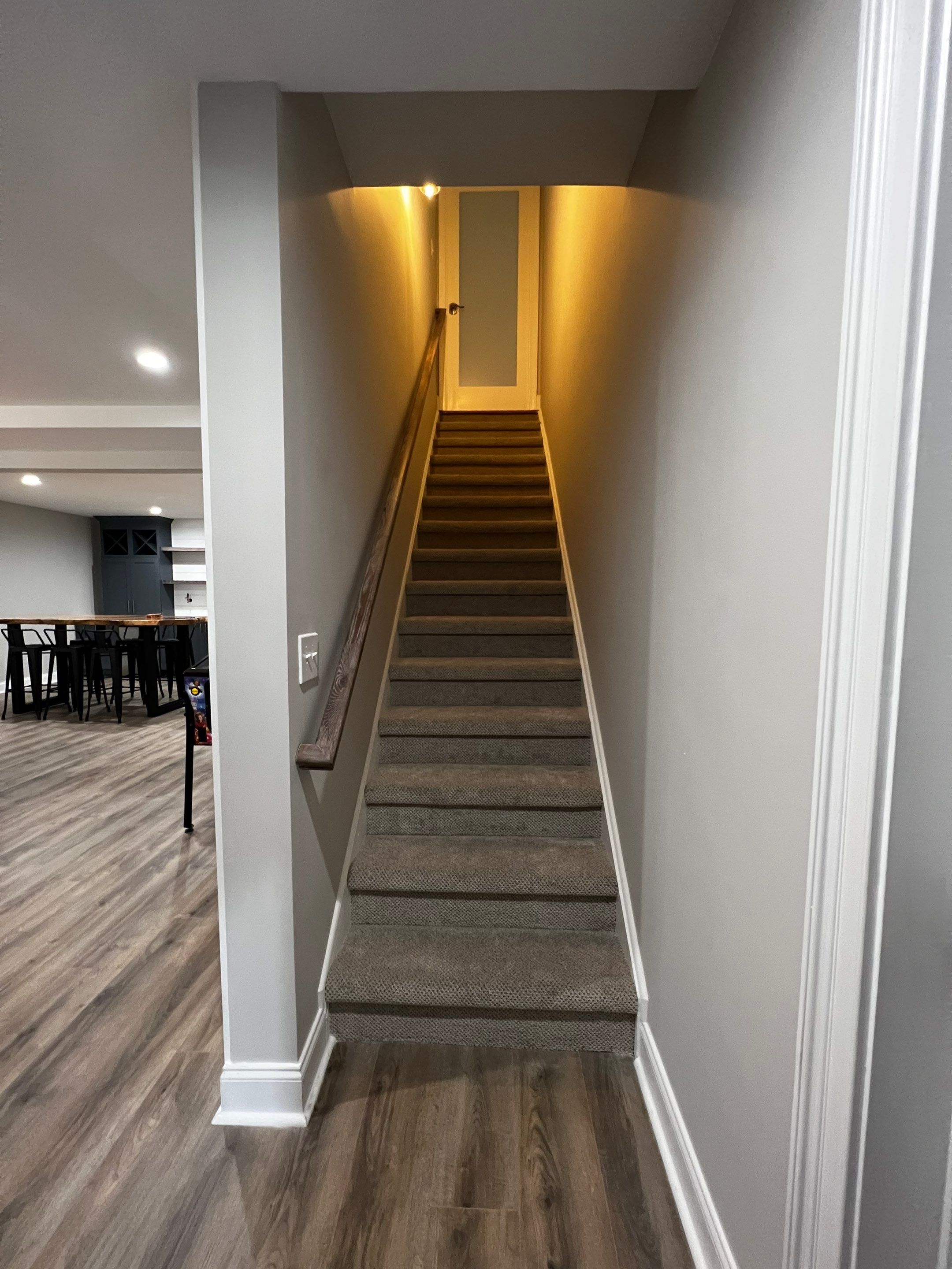 Modern Basement Remodeling in Woodstock with Custom Live-Edge Bar by Swift Home Renovations