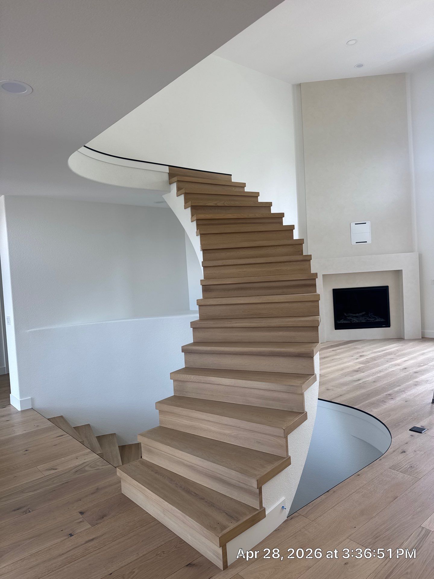 Curved Oak Staircase and Custom Metal Railing Installation in Lone Tree by LP Construction Services