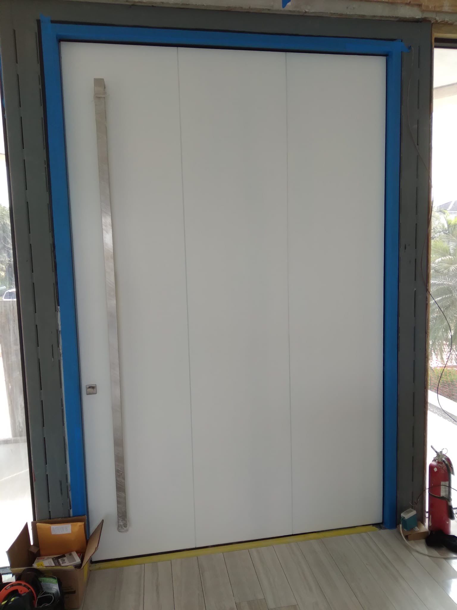 Custom Material Pivot Door installation by Impact Precious Wood Inc.