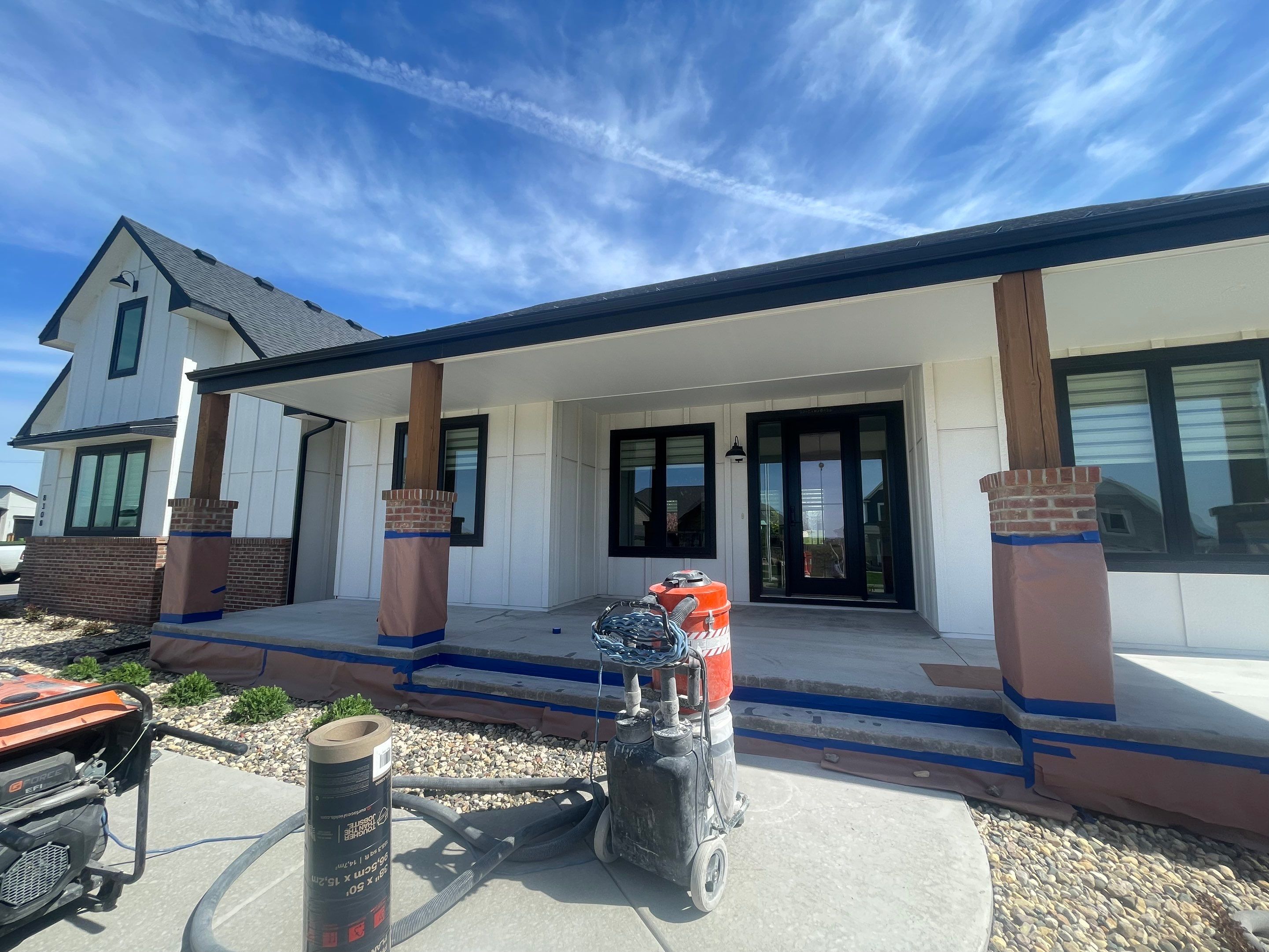 Grey Speckled Concrete Porch Coating for Sioux Falls Home by Select Painting, Coatings & Garage Cabinets