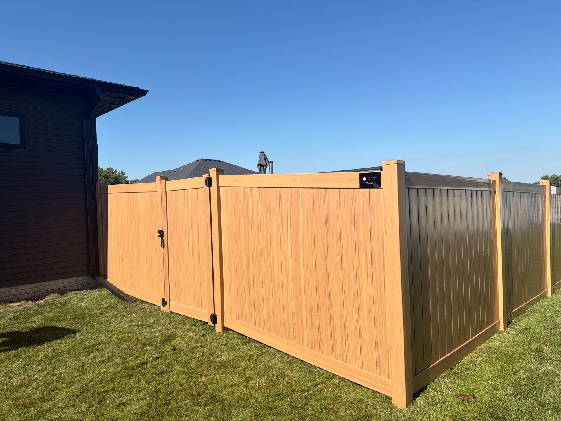 Residential Cypress Vinyl Privacy Fence Installation in Cedar Falls by Perfect Picket Fence and Stain
