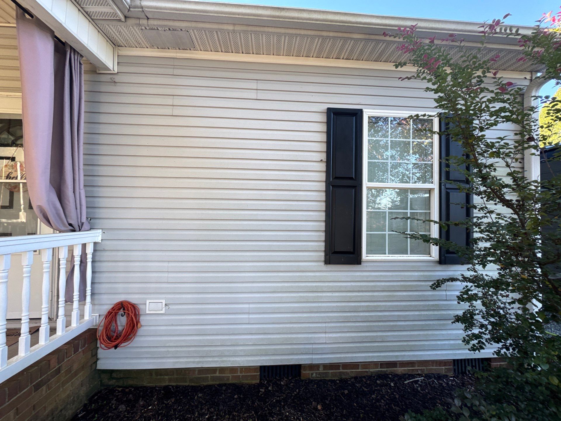 the service shown is cleaning the vinyl siding of a house to remove dirt and grime