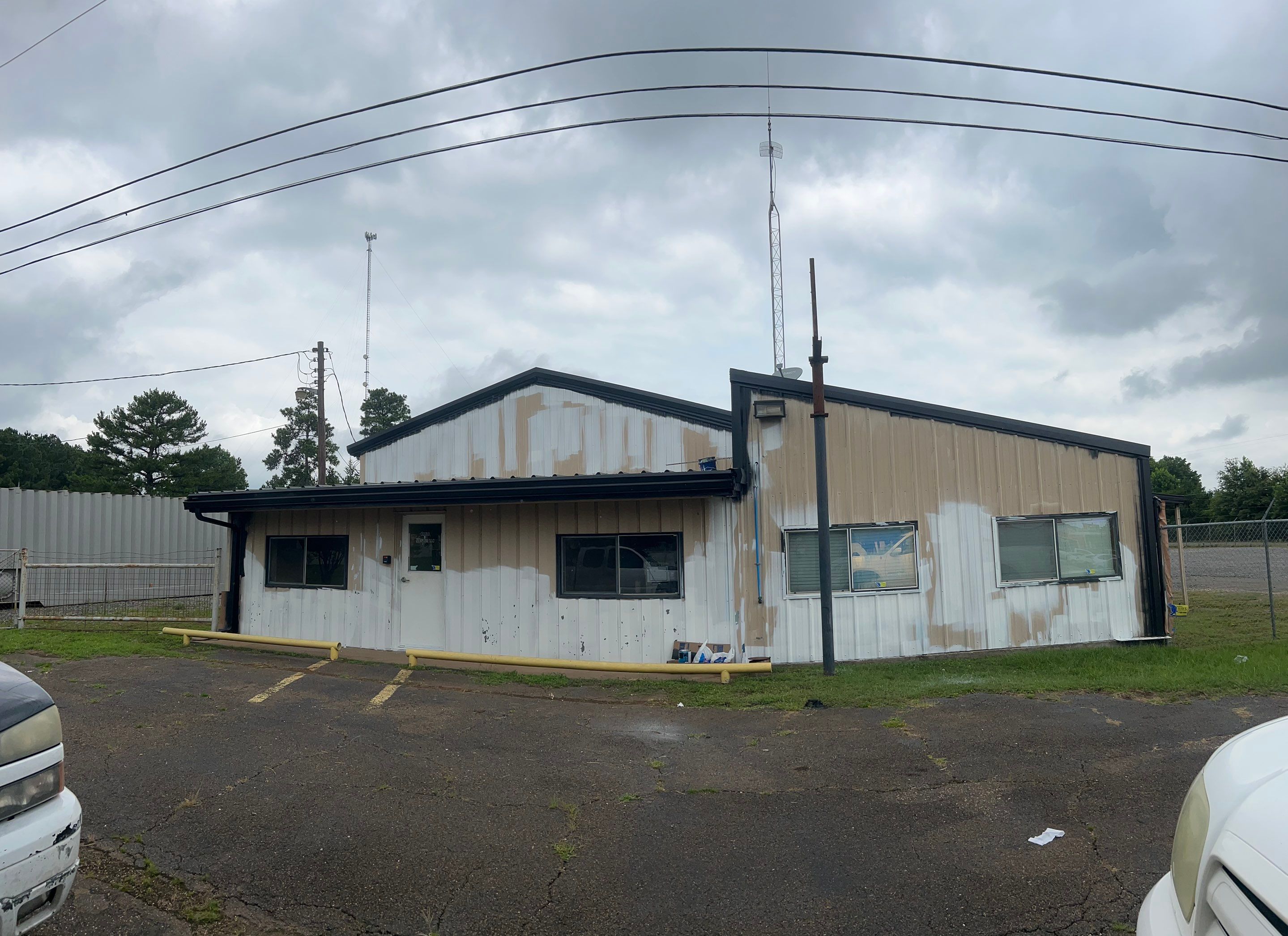 Exterior Painting in Kilgore, TX | Metal Building Transformation from White to Grey by Quality Coats Painting