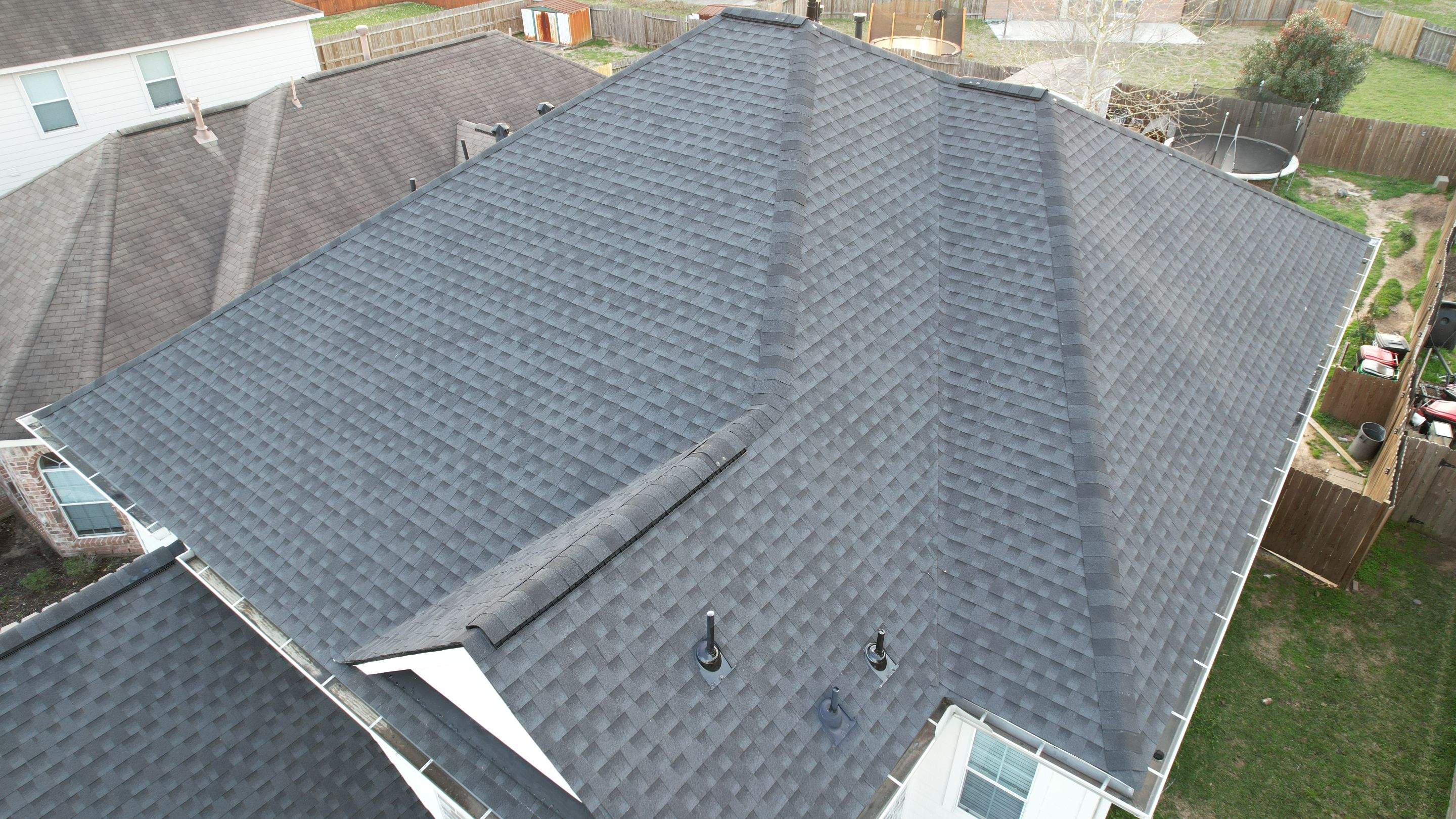 Slate-Gray Roof on Stone-Front Home — Spring, TX by PL Roofing & SB Roofing, LLC.