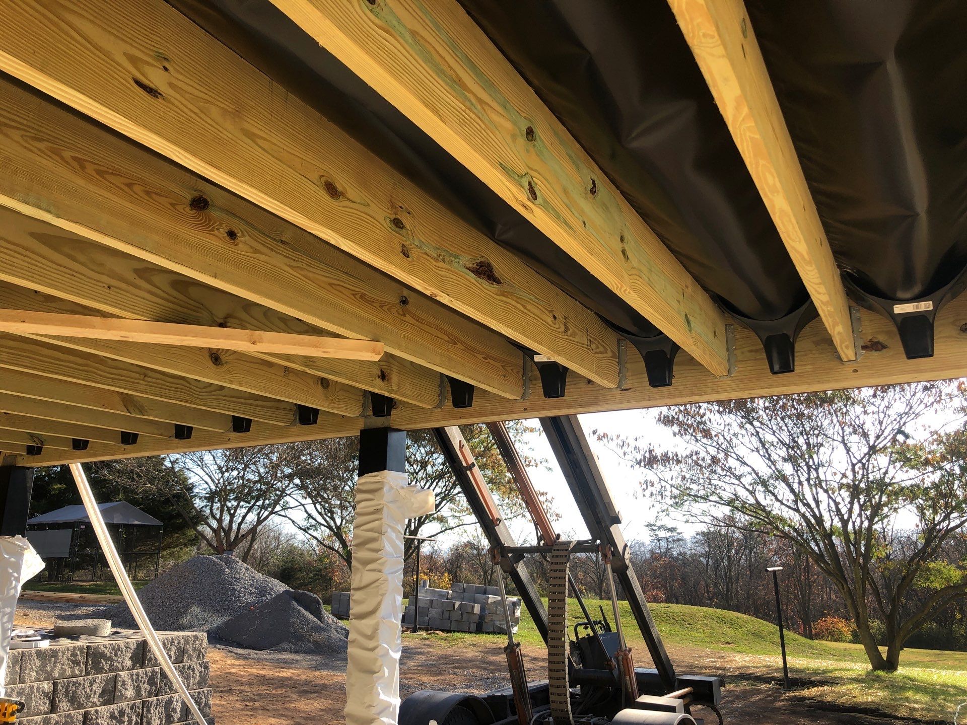 Green Metal Roof and Custom Covered Deck in Duncannon by Esh Builders