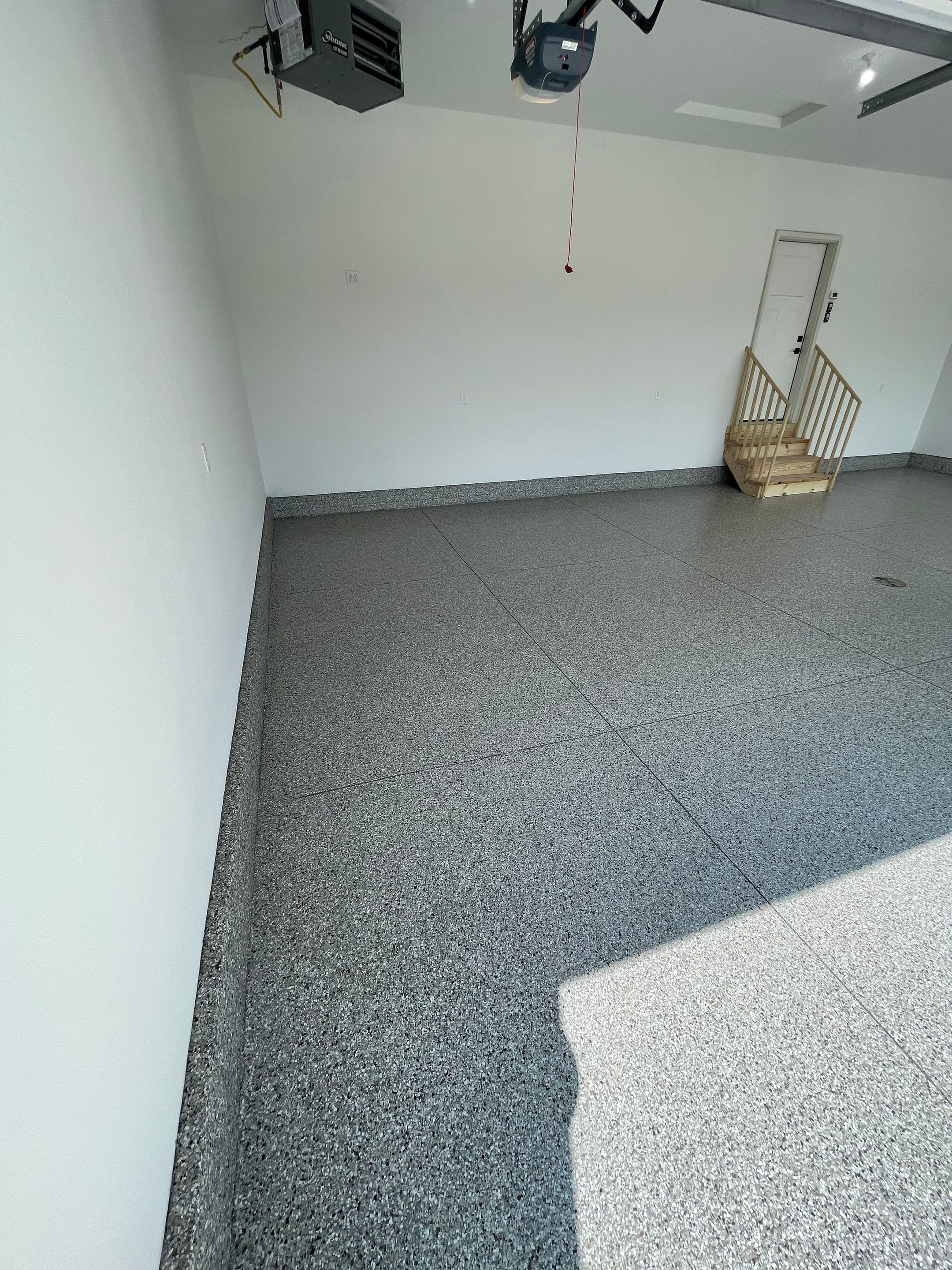 Grey Speckled Garage Floor Coating in Sioux Falls by Select Painting, Coatings & Garage Cabinets