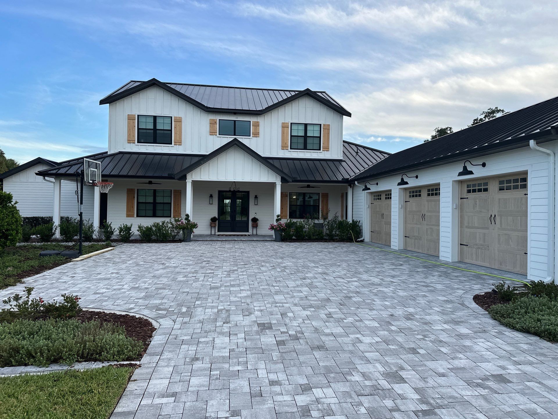 Complete Two-Story House Wash and Driveway Cleaning in Winding River Community, Bradenton, FL by Sunshine AquaWash