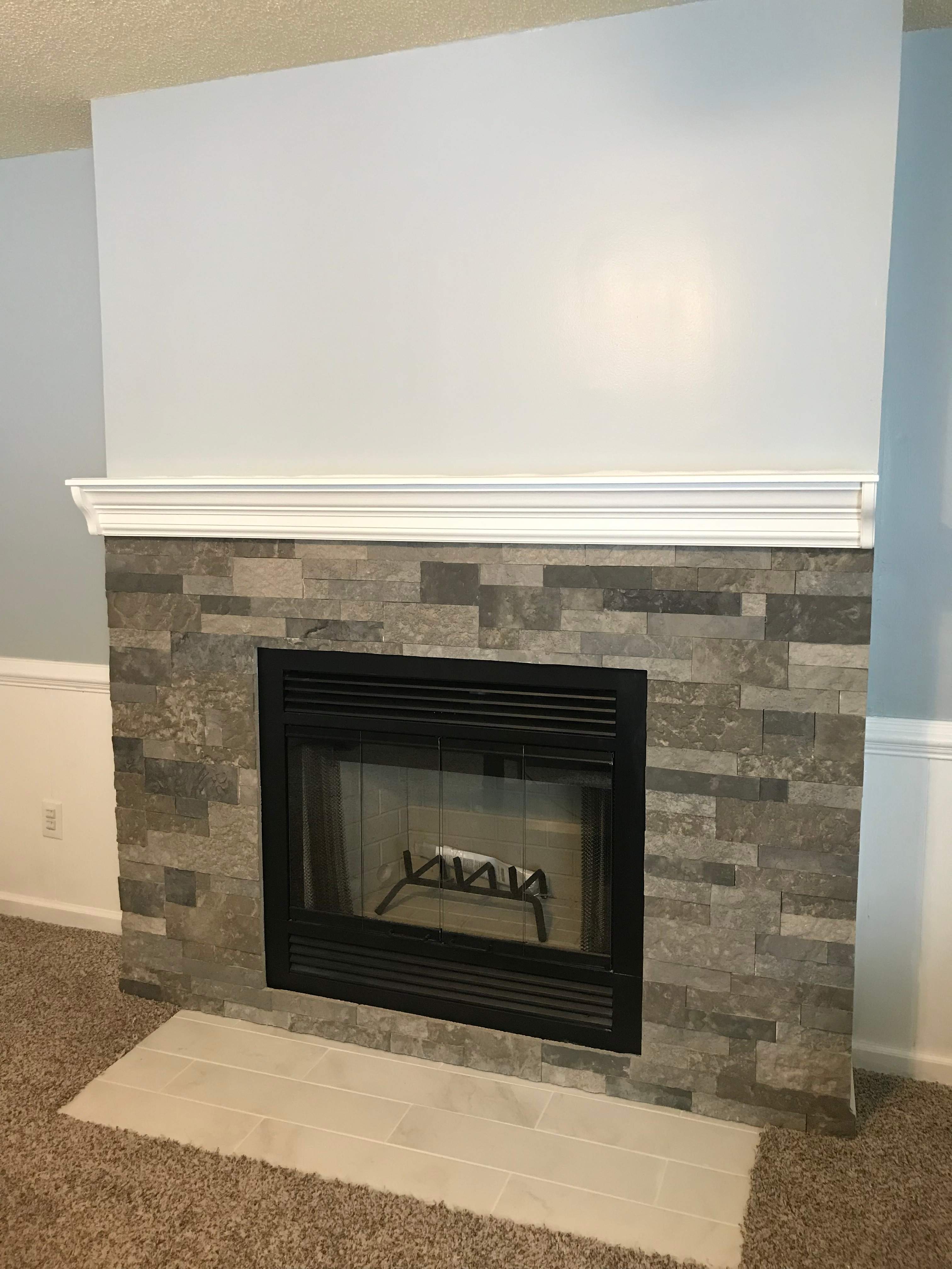 Wood Fireplace + stone + mantel by Premier Chimney and Roofing
