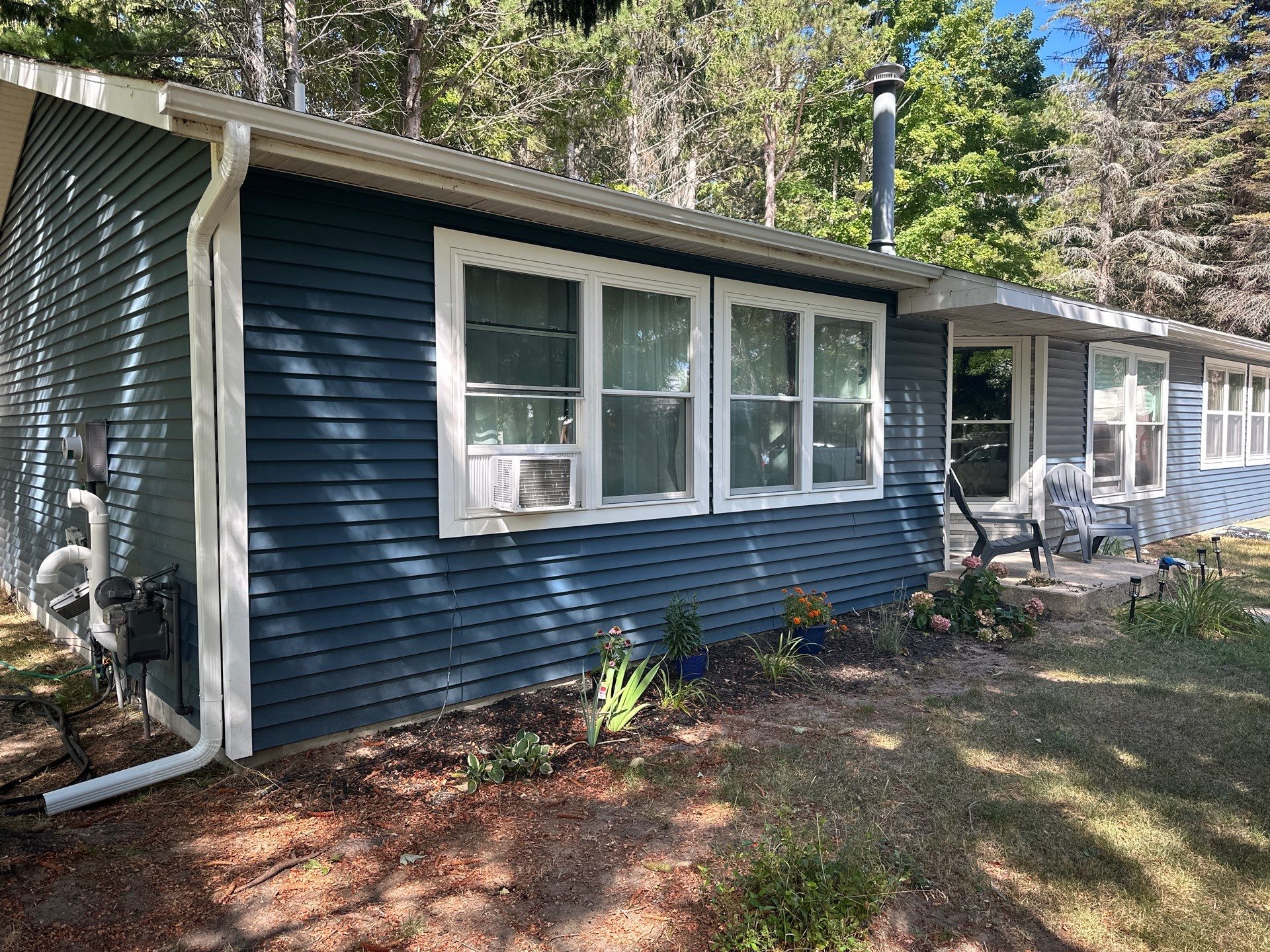 Residential White Gutter and Downspout Installation in Charlevoix