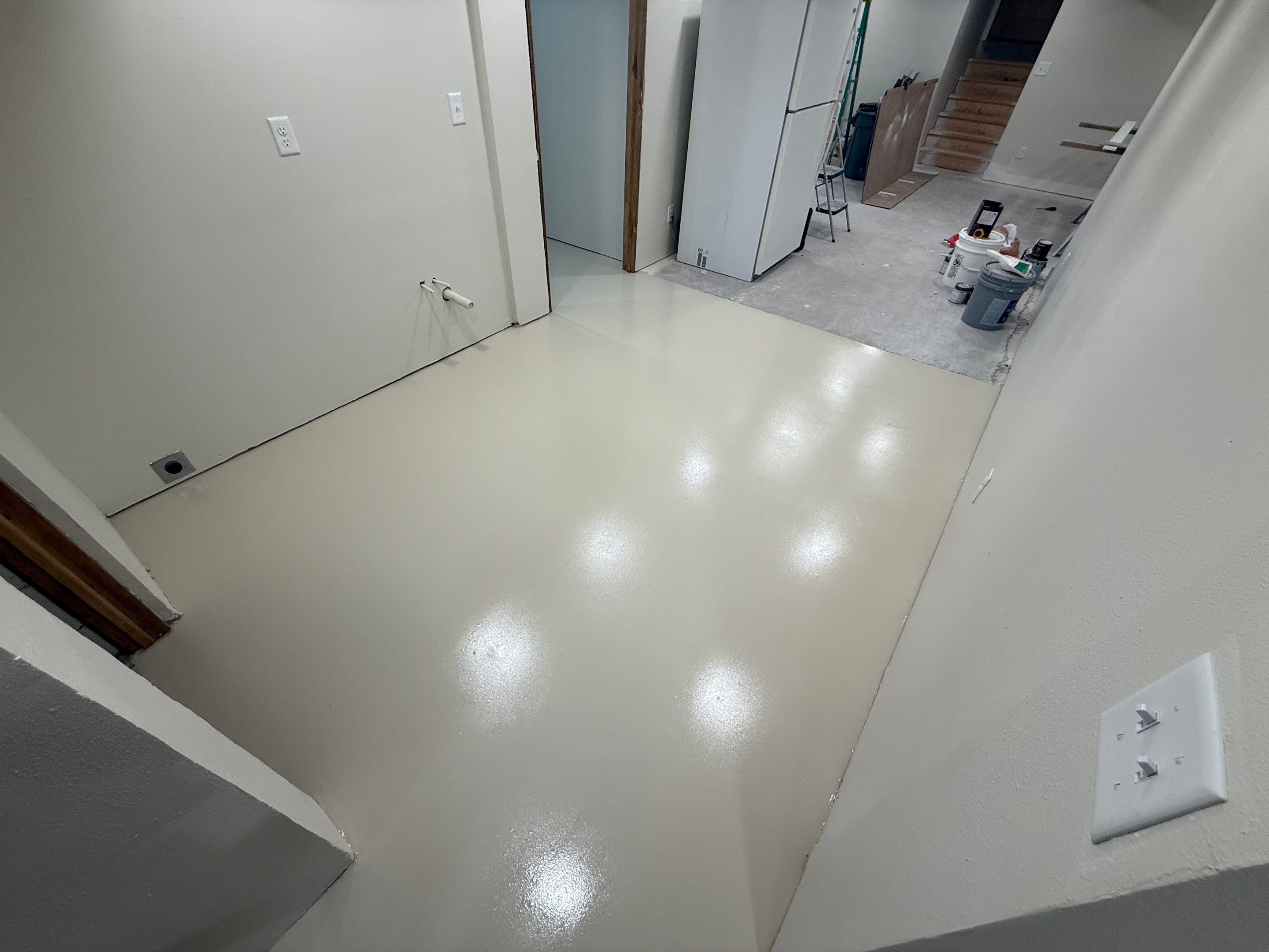 High-Gloss Epoxy Floor Coating and Basement Renovation in Rock Rapids by Select Painting, Coatings & Garage Cabinets