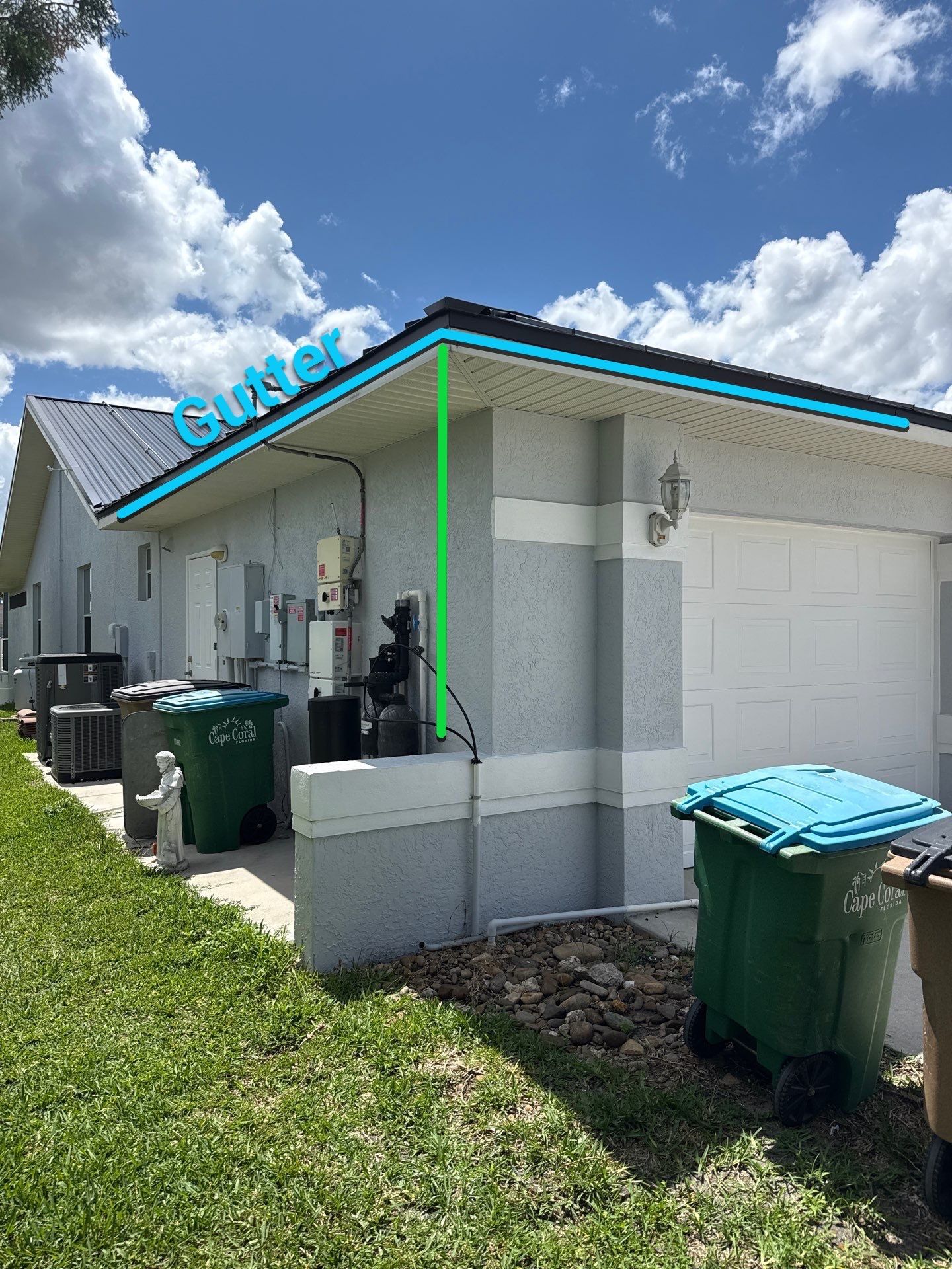 Black Seamless Gutters and White Downspouts in Cape Coral FL by Gutter Professors
