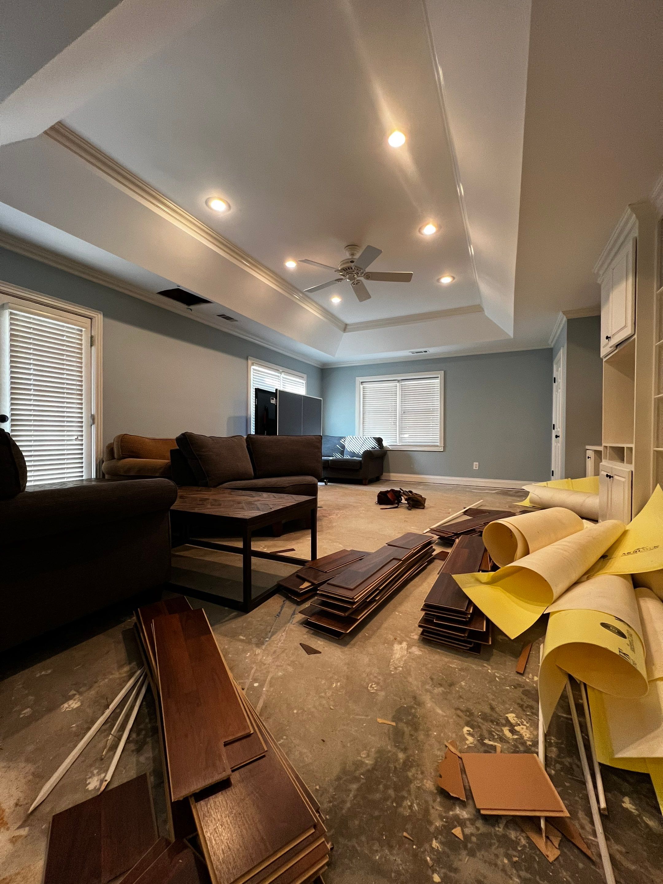 Finished Basement Remodeling with Dark Wood-Look Flooring and Custom Wainscoting by Swift Home Renovations 
