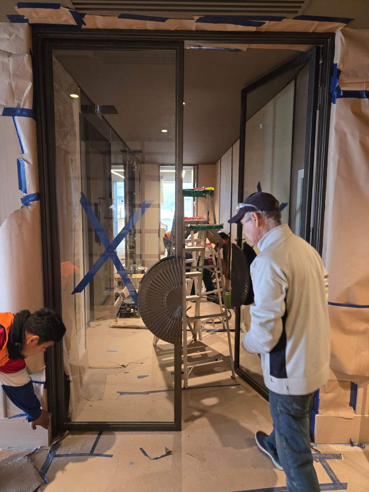 Modern Black Frame Double Door Installation with Custom Radial Hardware by Solara Custom Living