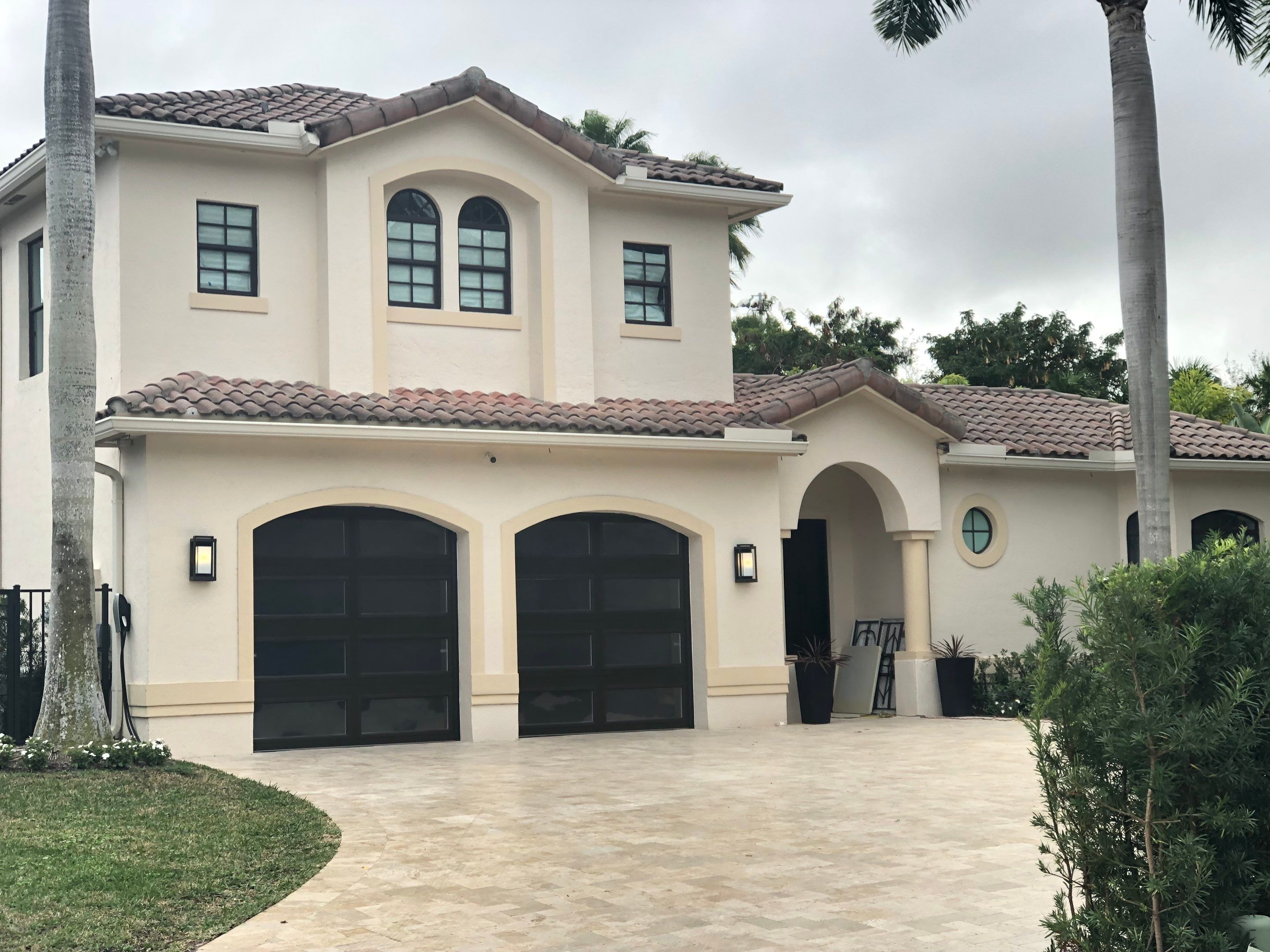 Modern Bronze Garage Door Installation With Frosted Glass in Boca Raton by The Door Doctor of South Florida, Inc.