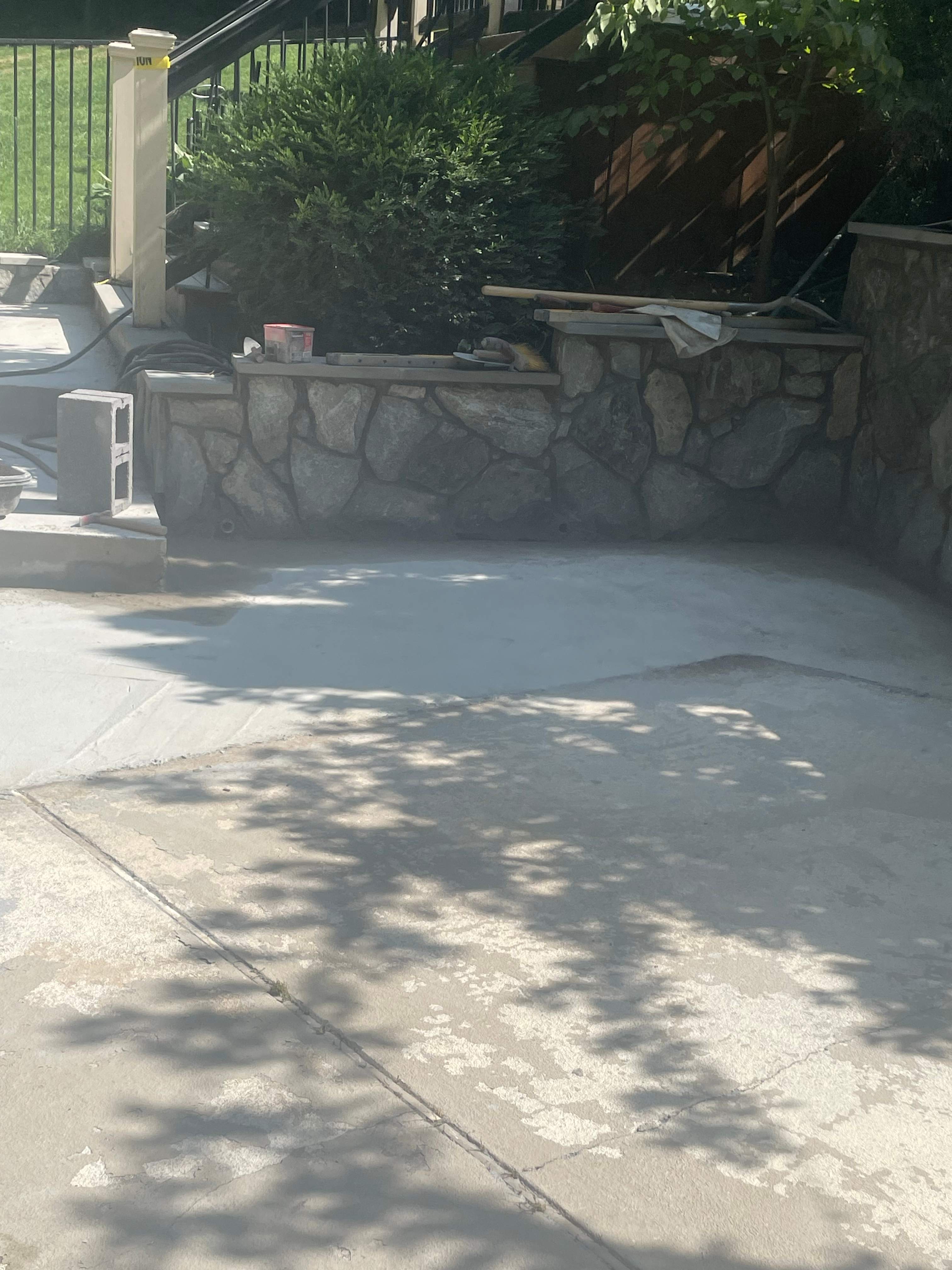 Pool Surround remodel with retaining walls, new waterfall and water slide by Fairfax Contractors, LLC