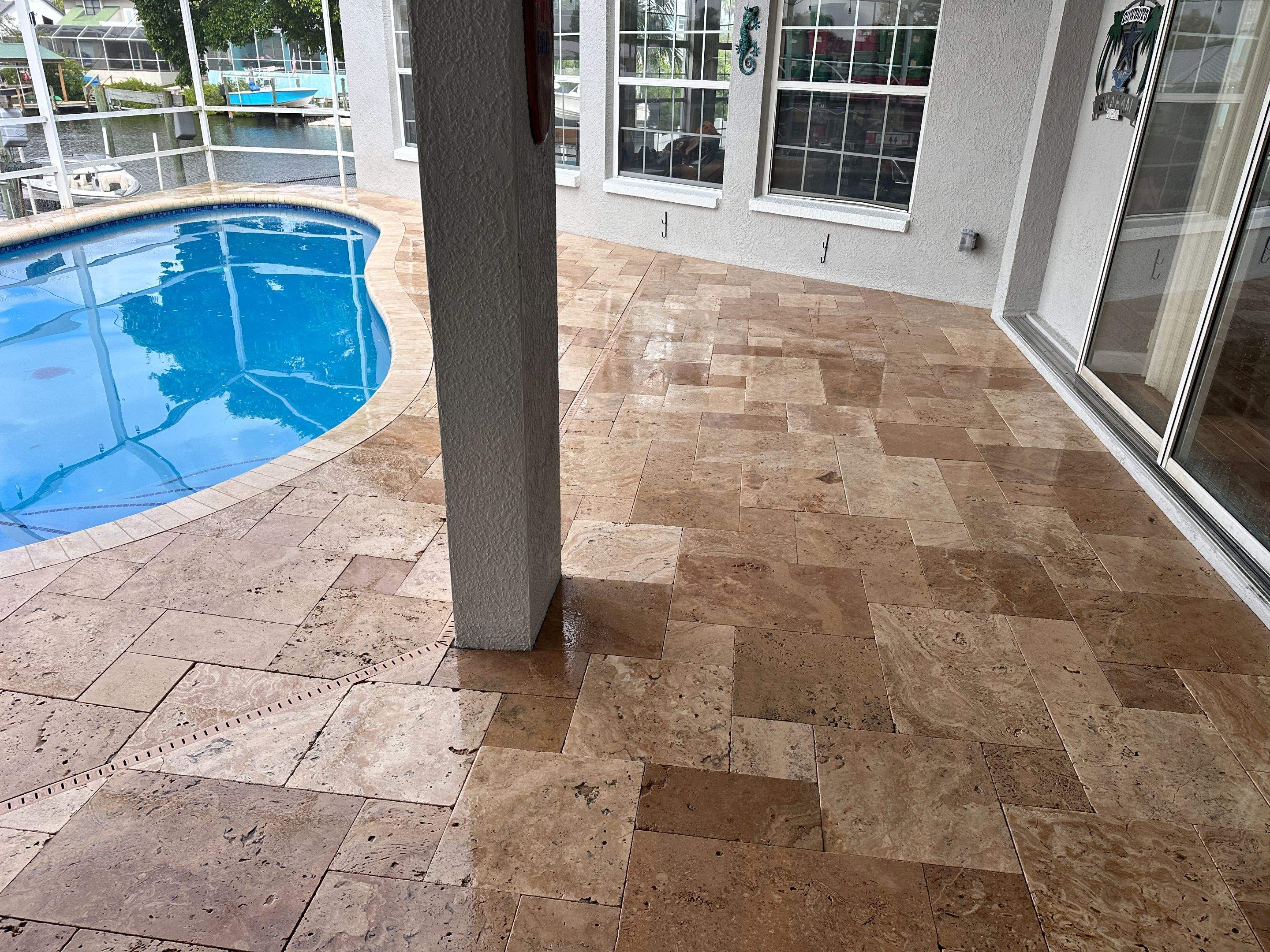 Travertine Sealing and Stripping for a Waterfront Pool Deck in Apollo Beach by Supreme Paver Experts
