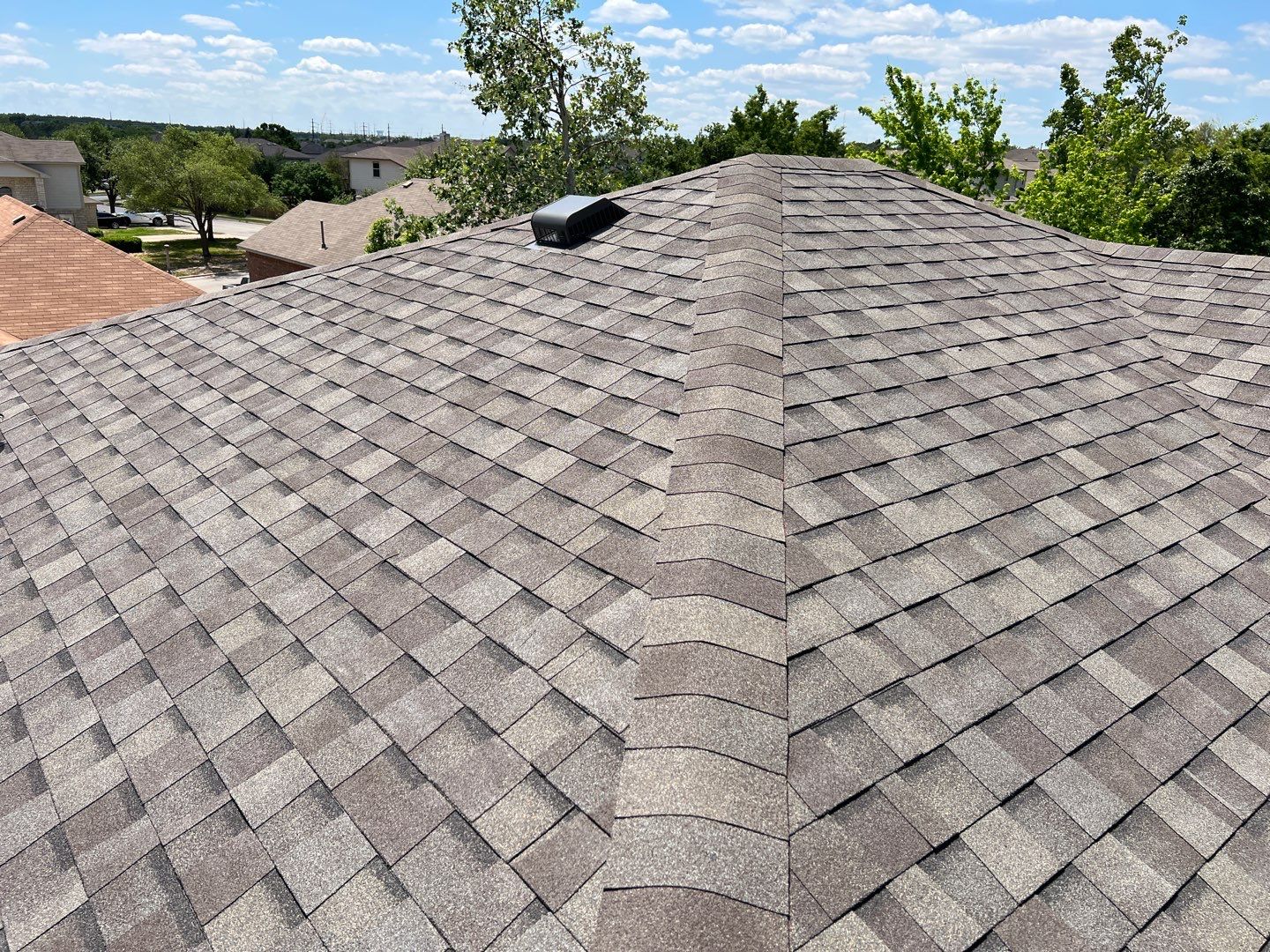 Wind damaged roof replacement by Oakwood Roofing and Construction, LLC