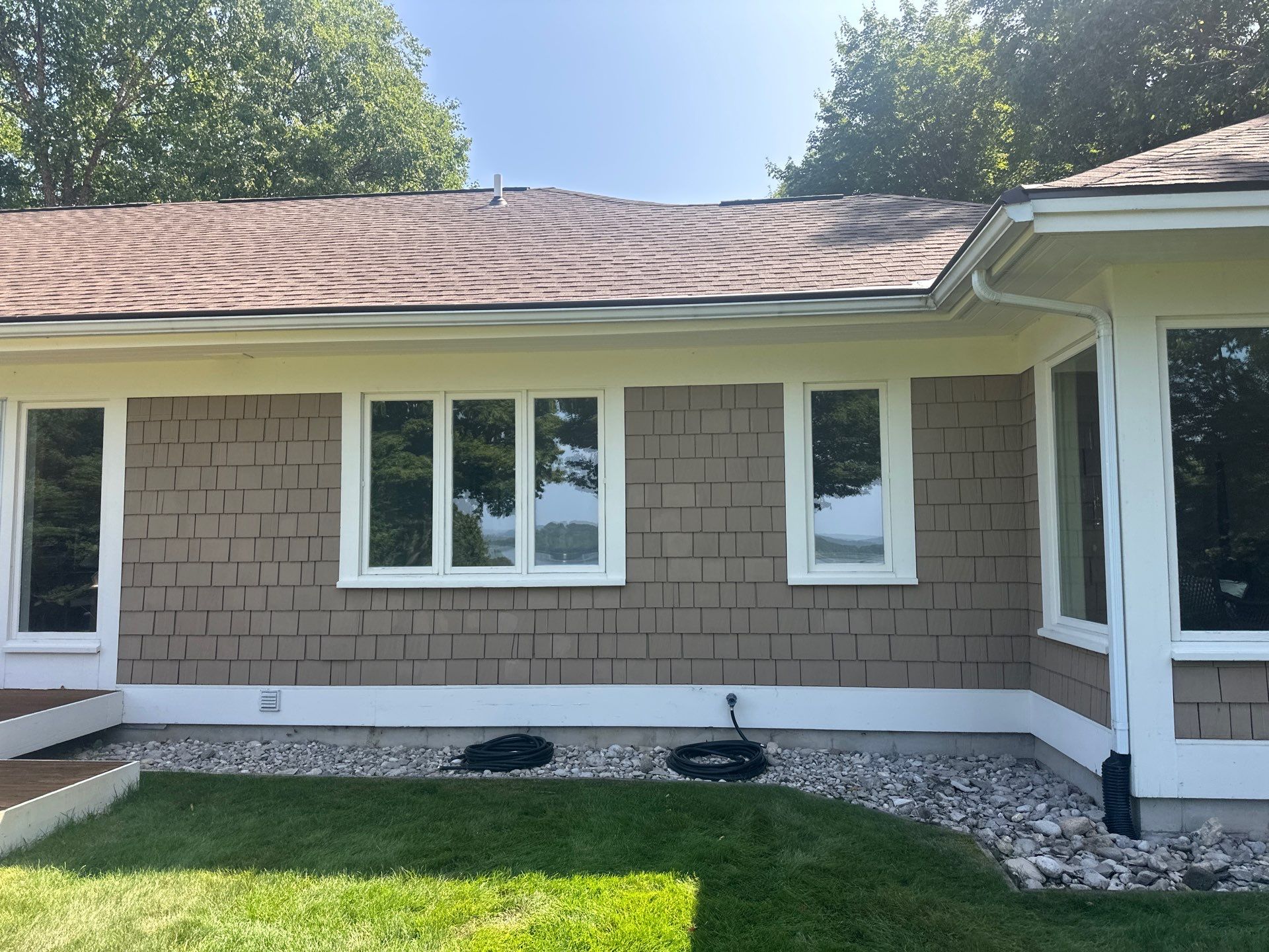 Gutter Helmet Installation for a Traverse City Residence With Shake Siding by Rainbow Seamless Systems