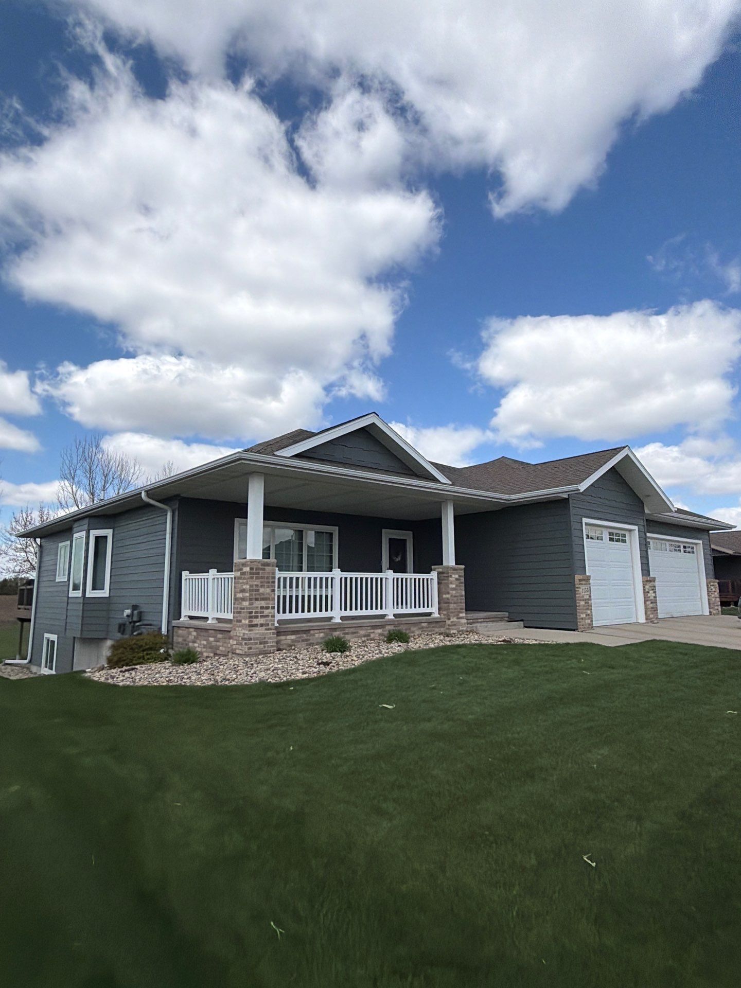 Madison Exterior Remodel with Dark Gray Siding and Stone Accents by Select Painting, Coatings & Garage Cabinets