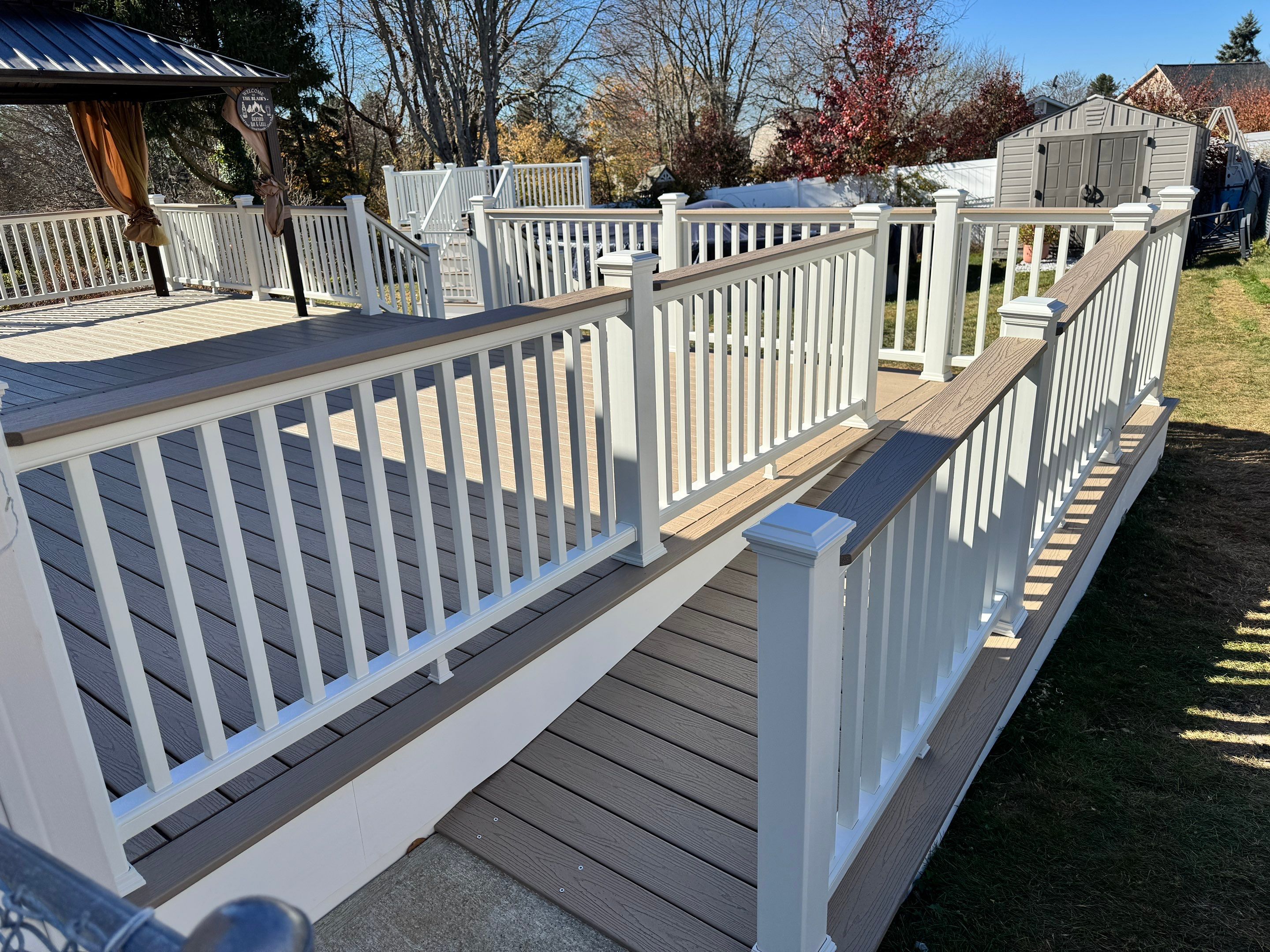 New pool deck and main deck resurface using Trex Transcend Rope Swing boards, White railing and Lattice by DiGiorgi Roofing and Siding Inc