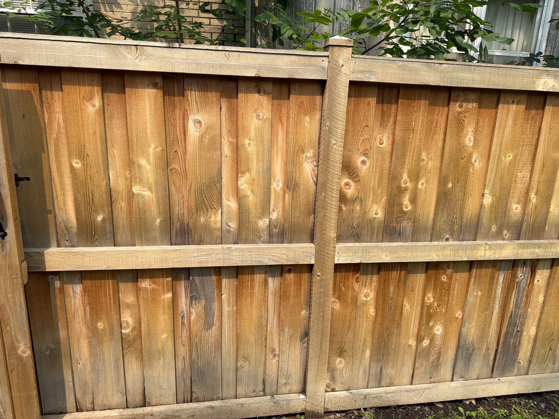 Wood fence cleaning and sealing by Northern Power Washing LLC.