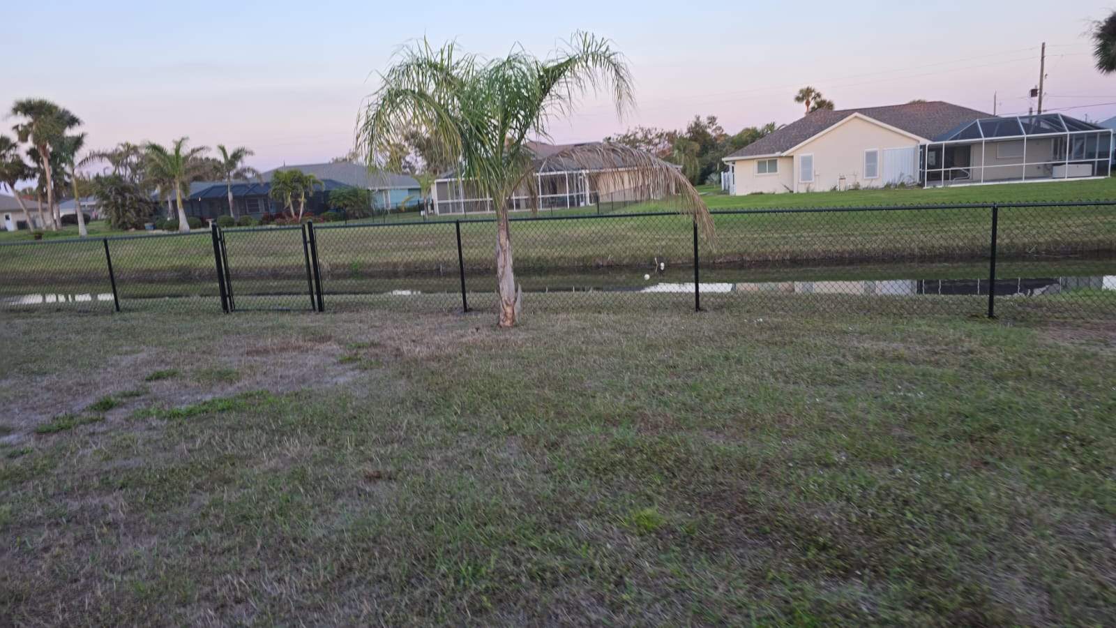 Waterfront Black Chain Link Fence Installation in Rotonda West by True Fence LLC