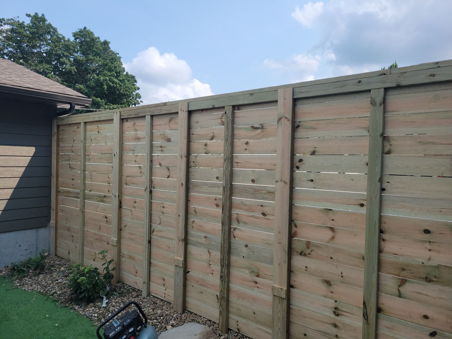 Modern Horizontal Slat Wood Privacy Fence Installation in Cedar Falls by Perfect Picket Fence and Stain