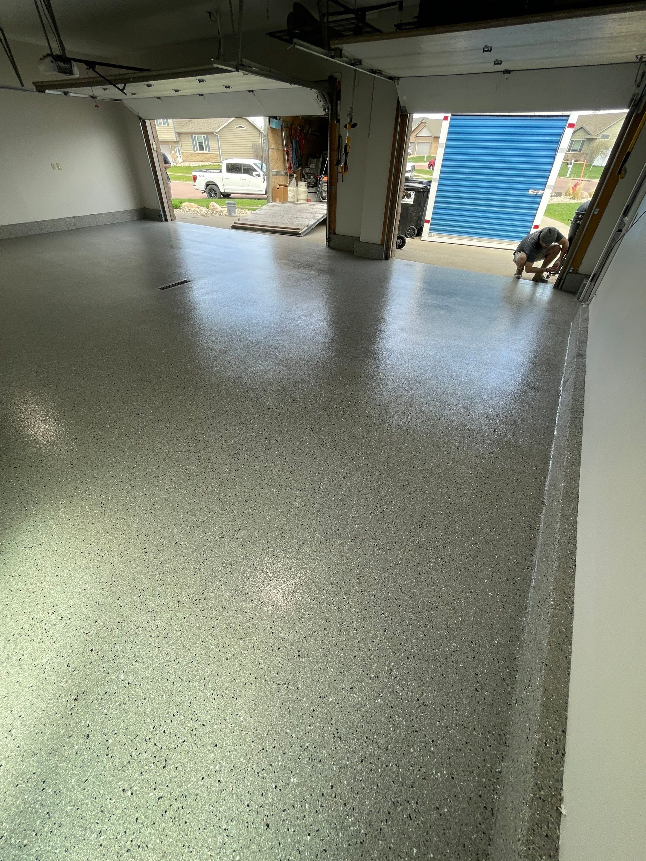 Residential Garage Floor Coating with Grey Speckled Epoxy Finish by Select Painting, Coatings & Garage Cabinets