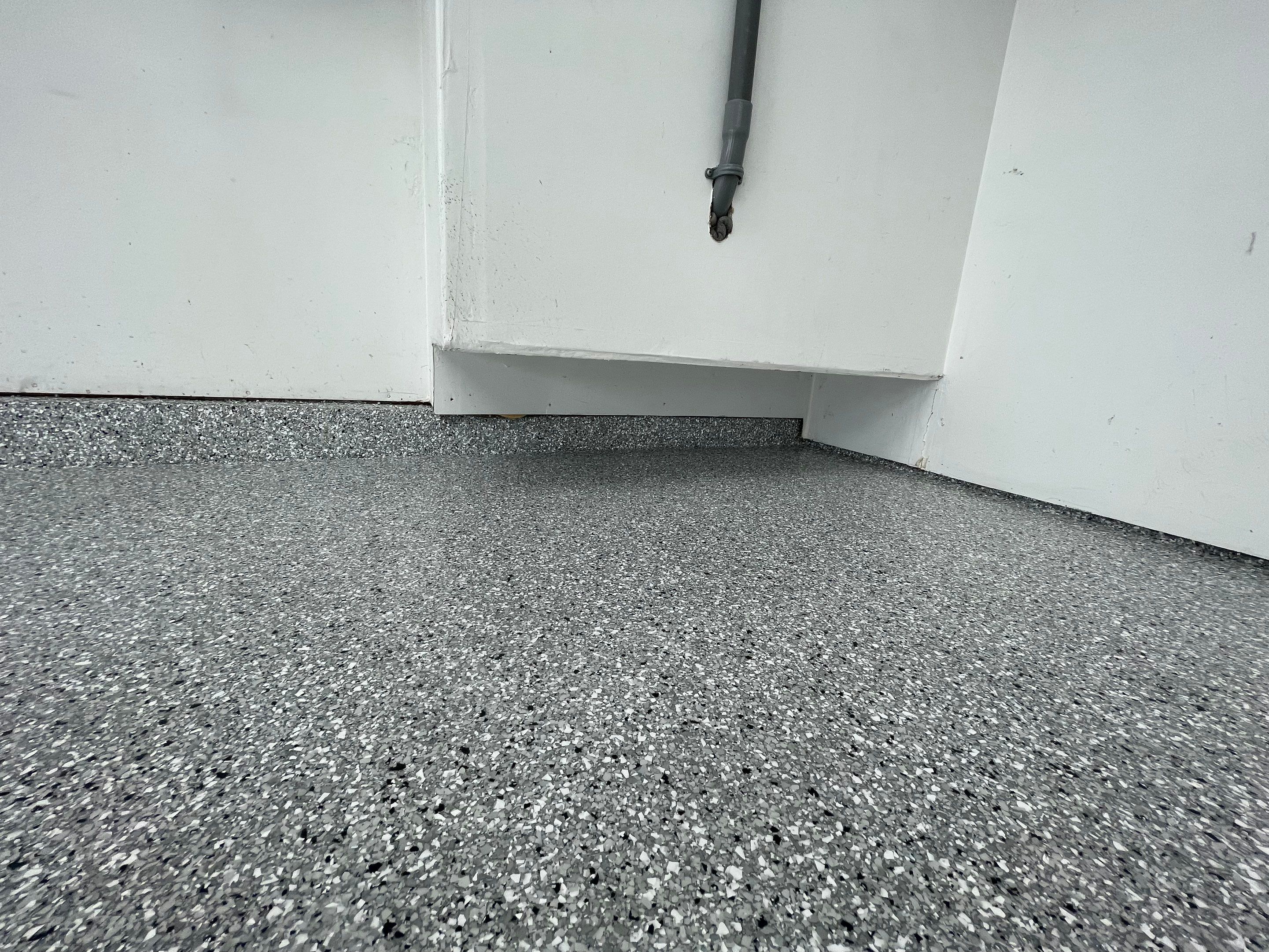 Feather Gray Epoxy Floor Coating Installation in Sioux Falls by Select Painting, Coatings & Garage Cabinets