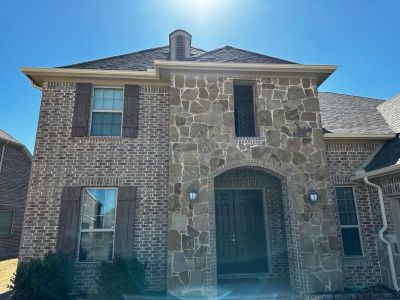 Brown brick/mixed stone with Malarkey Natural Wood
