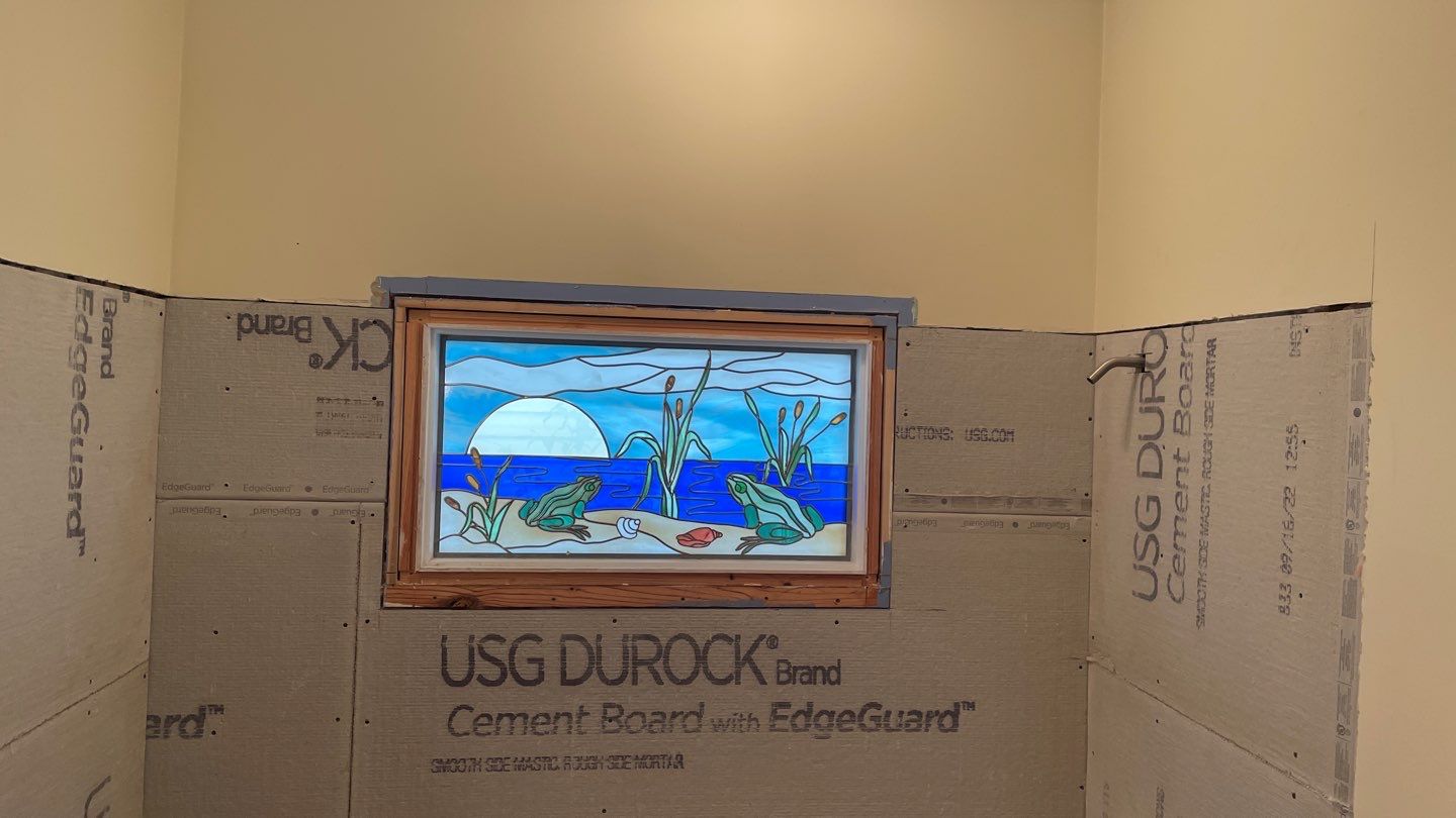 Shower Transition Highlighting Stained Glass Window by Footprints Floors of Coastal Carolina