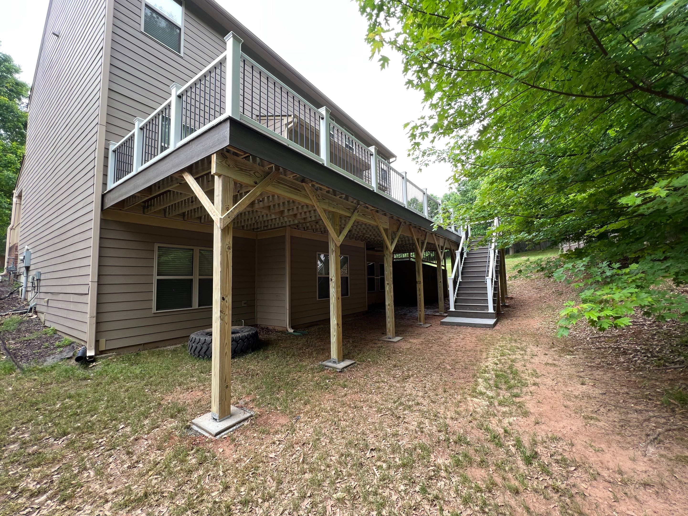 Custom Elevated Deck Replacement with White and Black Railings by Swift Home Renovations