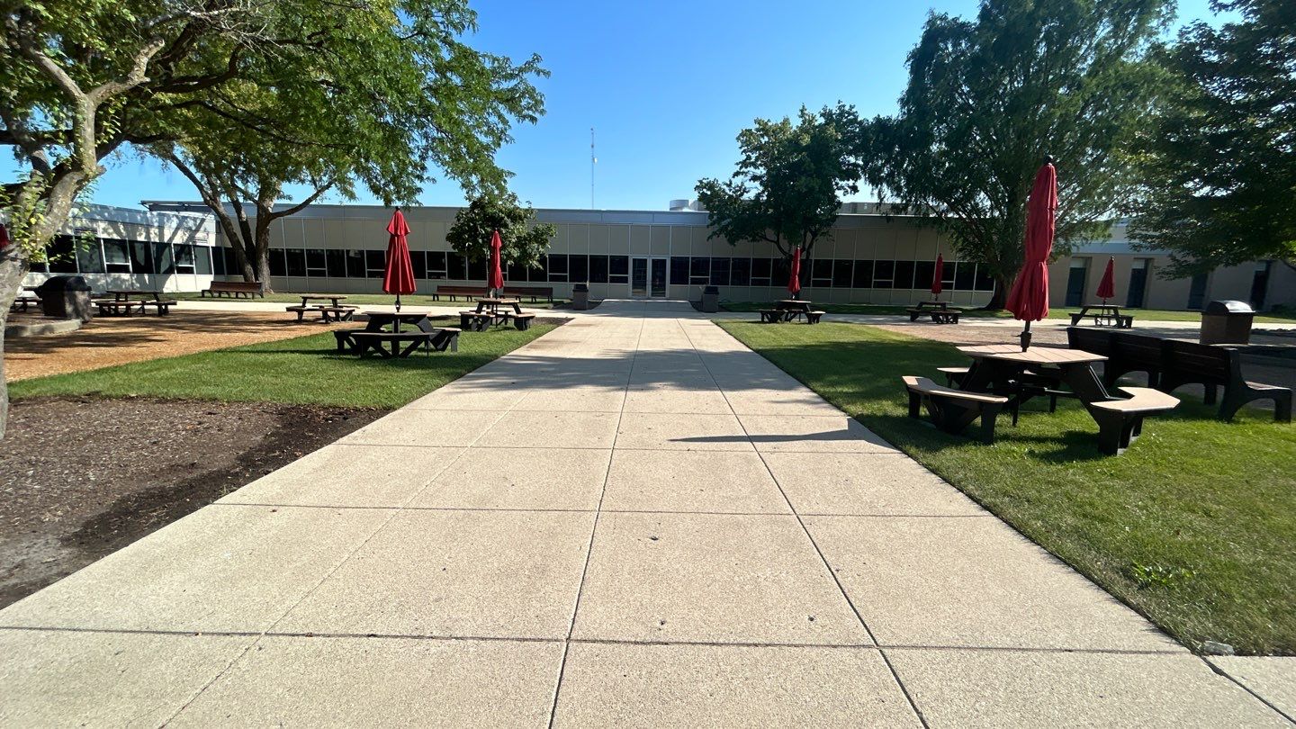 concrete using Algaecide, soft wash soap by Northern Power Washing LLC.