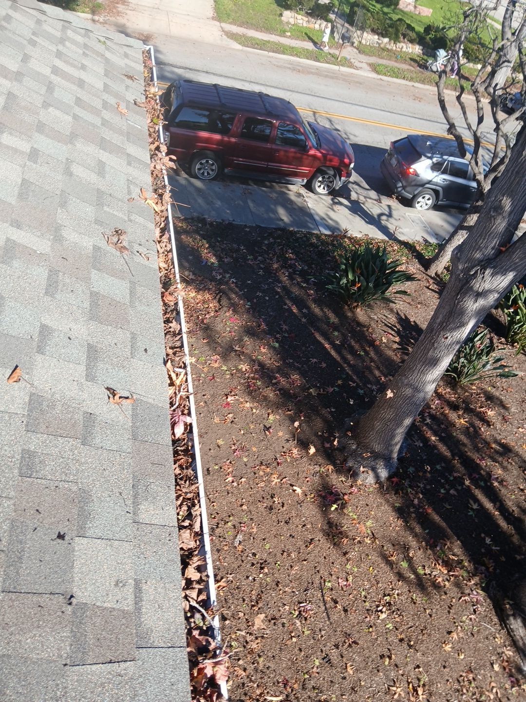 Commercial gutter cleaning Santa Barbara, CA before photo with filled gutters