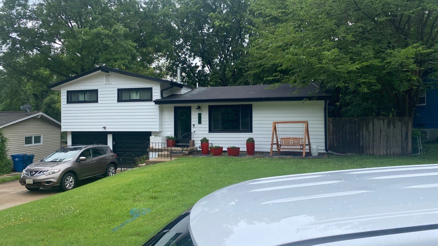 White Craneboard Siding and Heartland Window Installation in Parkville by EEC Windows, Siding & Roofing