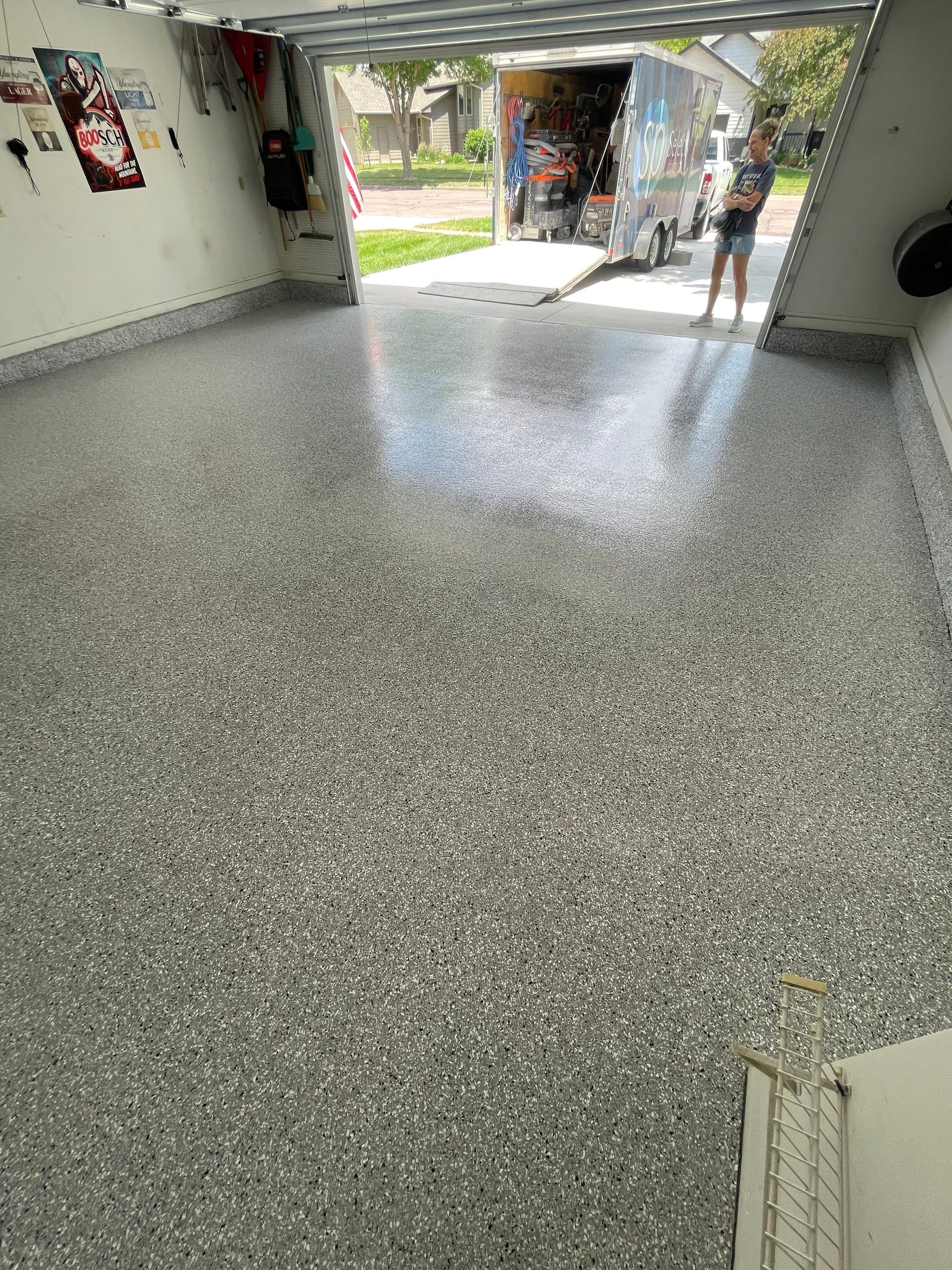Residential Garage Floor Coating with Feather Grey Finish in Sioux Falls by Select Painting, Coatings & Garage Cabinets