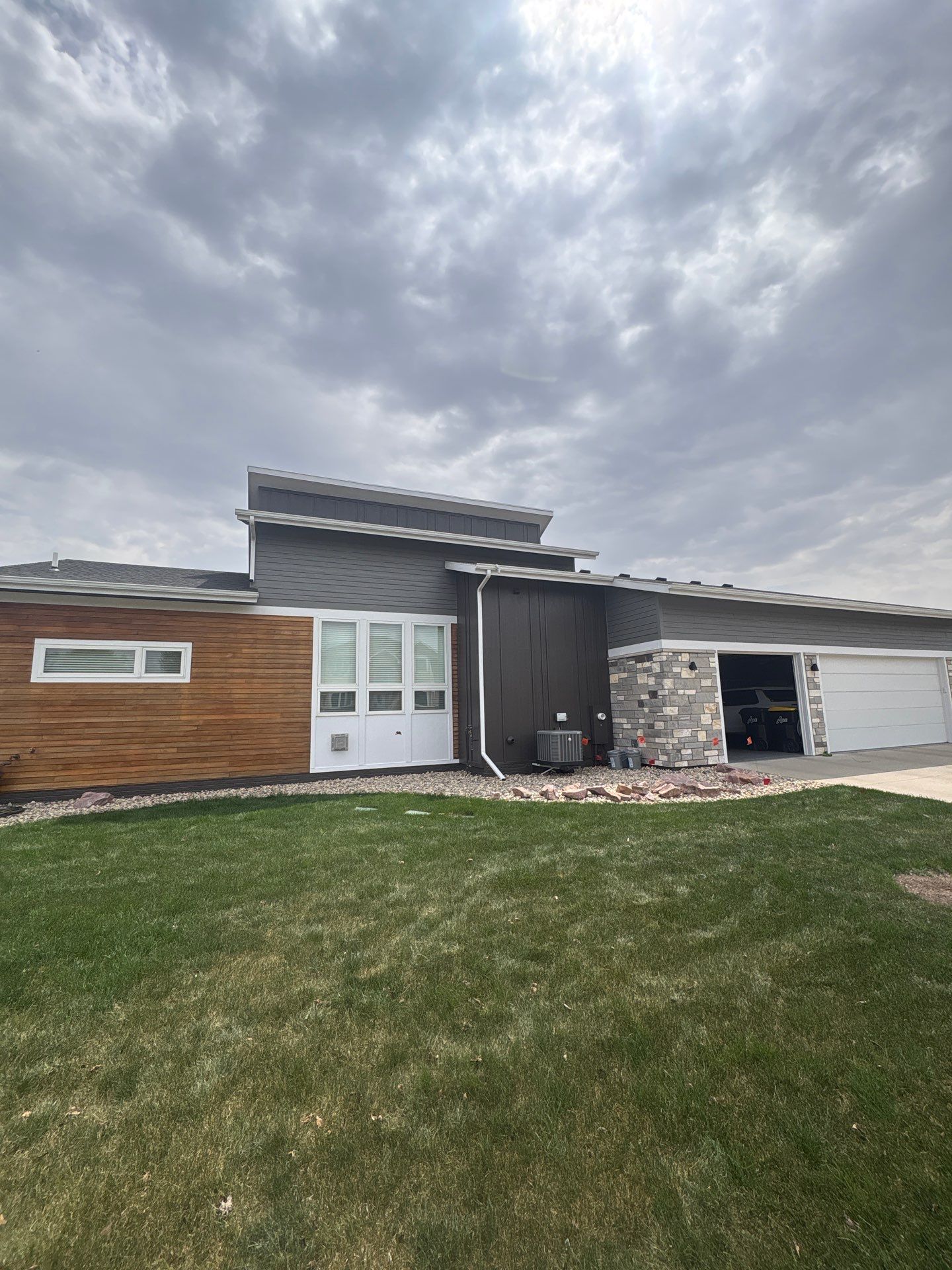 Modern Exterior Transformation Featuring Dark Board and Batten Siding in Sioux Falls by Select Painting, Coatings & Garage Cabinets