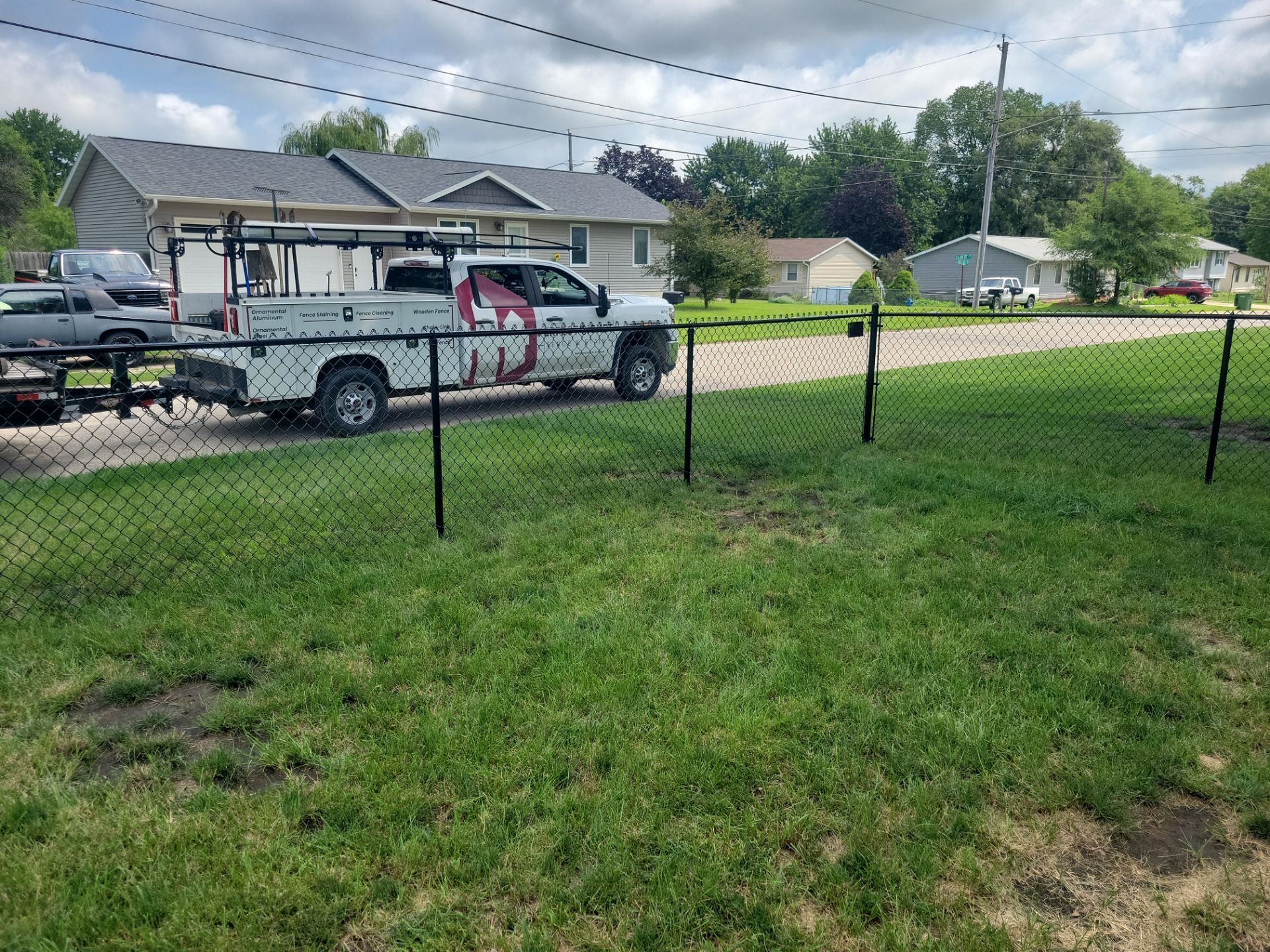 Black Chain Link Perimeter Fence Installation in Waterloo by Perfect Picket Fence and Stain