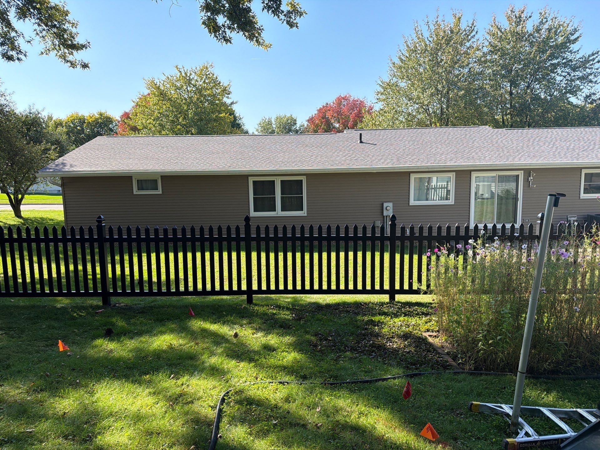Black Vinyl Spaced Picket Fence Installation in Cedar Falls by Perfect Picket Fence and Stain