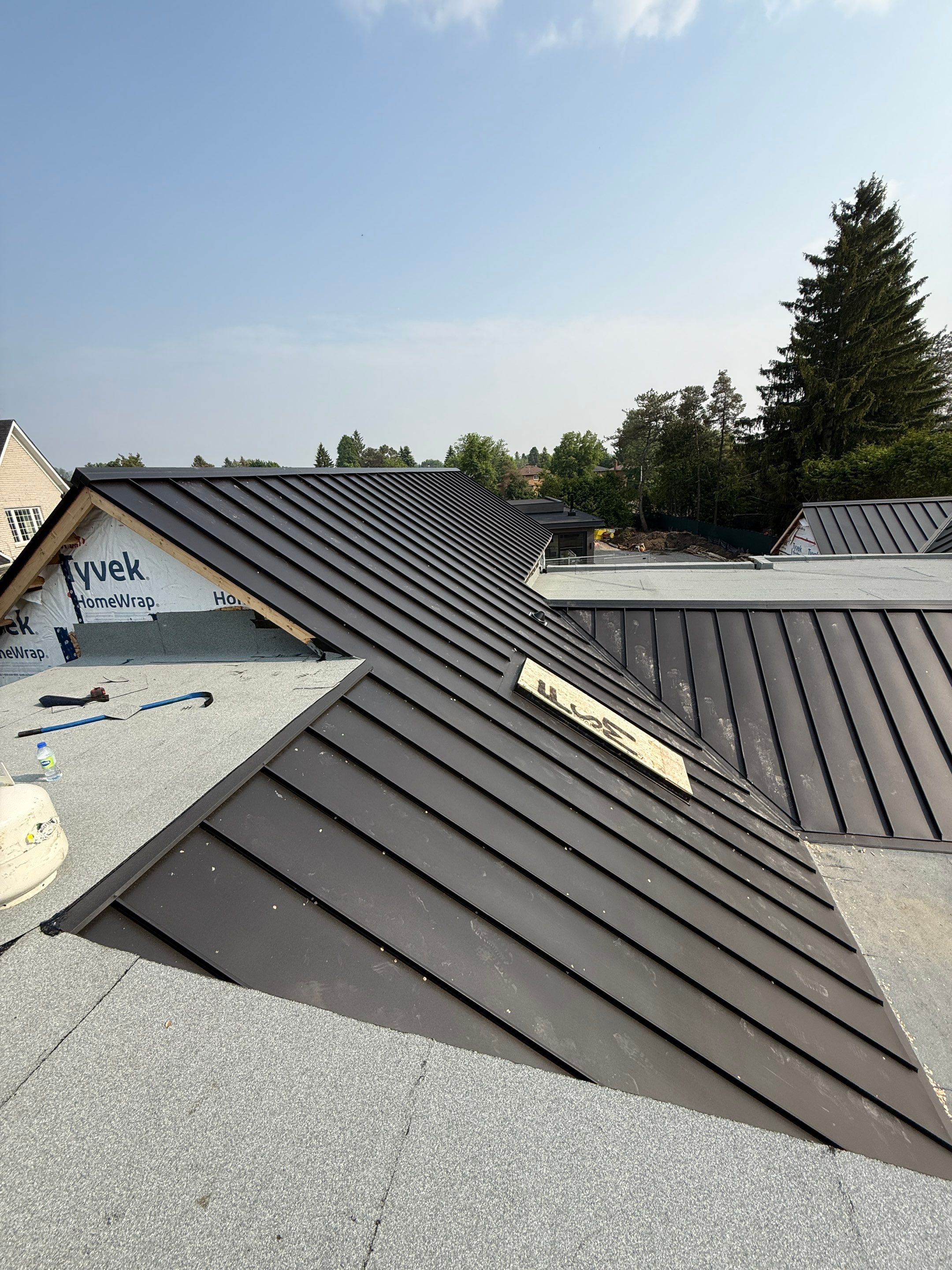 Custom Home Jet Black 24 GA Standing Seam Roof  by Jay Carter Roofing & Sheet Metal